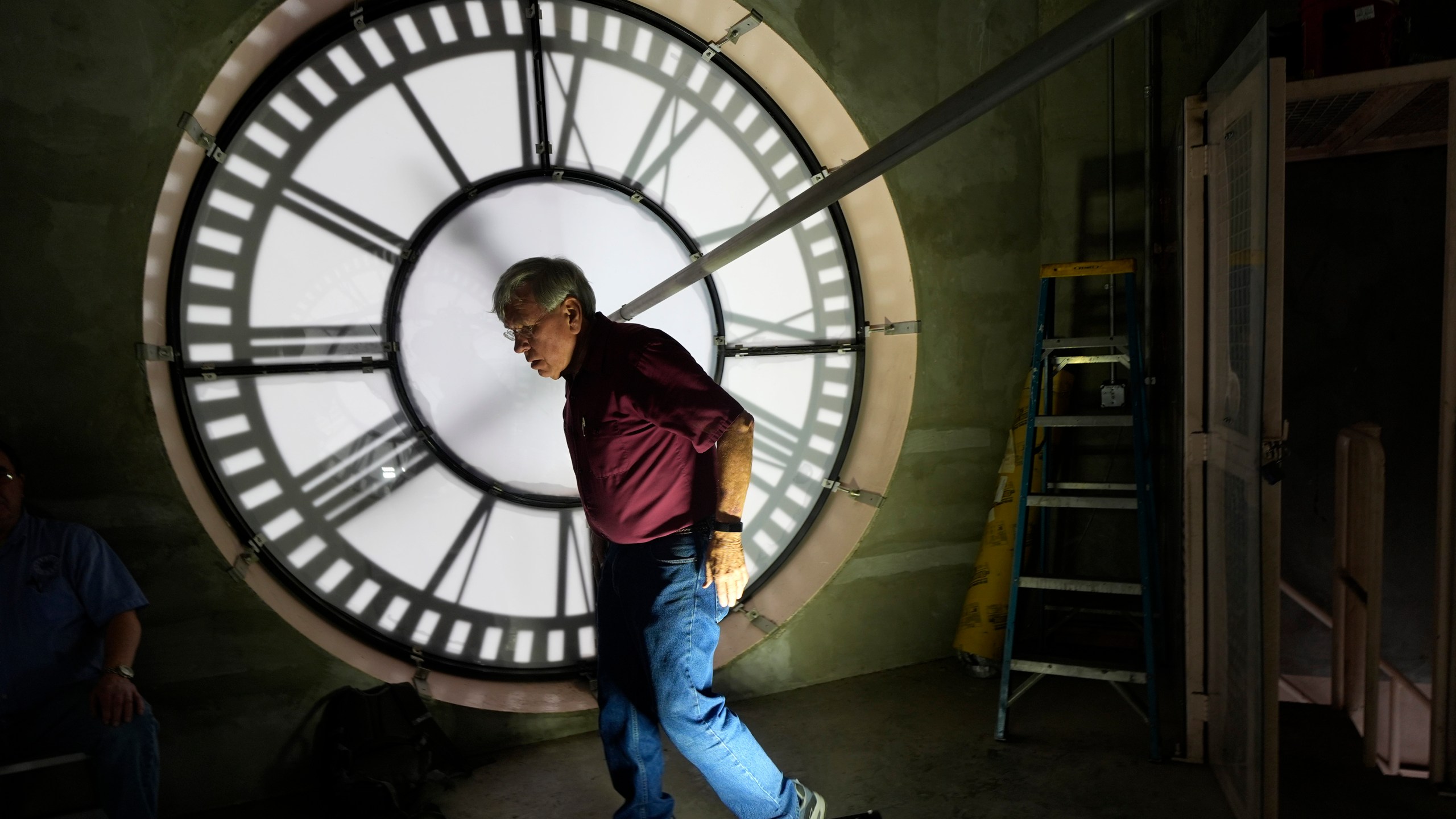 Don Bugh walks inside the historic clock tower atop the Dallas County Courthouse, Thursday, March 7, 2024, in Dallas. The mechanical clock built in 1890 requires hand lubrication and reseting twice a year with daylight savings time. (AP Photo/LM Otero)