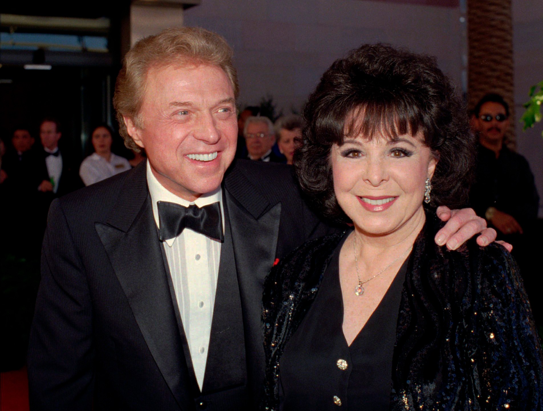 FILE - Singer Steve Lawrence, left, and his wife Eydie Gorme arrive at a black-tie gala called honoring Frank Sinatra in Las Vegas on May 30, 1998. Lawrence, a singer and top stage act who as a solo performer and in tandem with his wife Gorme kept Tin Pan Alley alive during the rock era, died Wednesday, March 6, 2024 at age 88. Gorme died on Aug. 10, 2013. (AP Photo/Lennox McLendon, File)