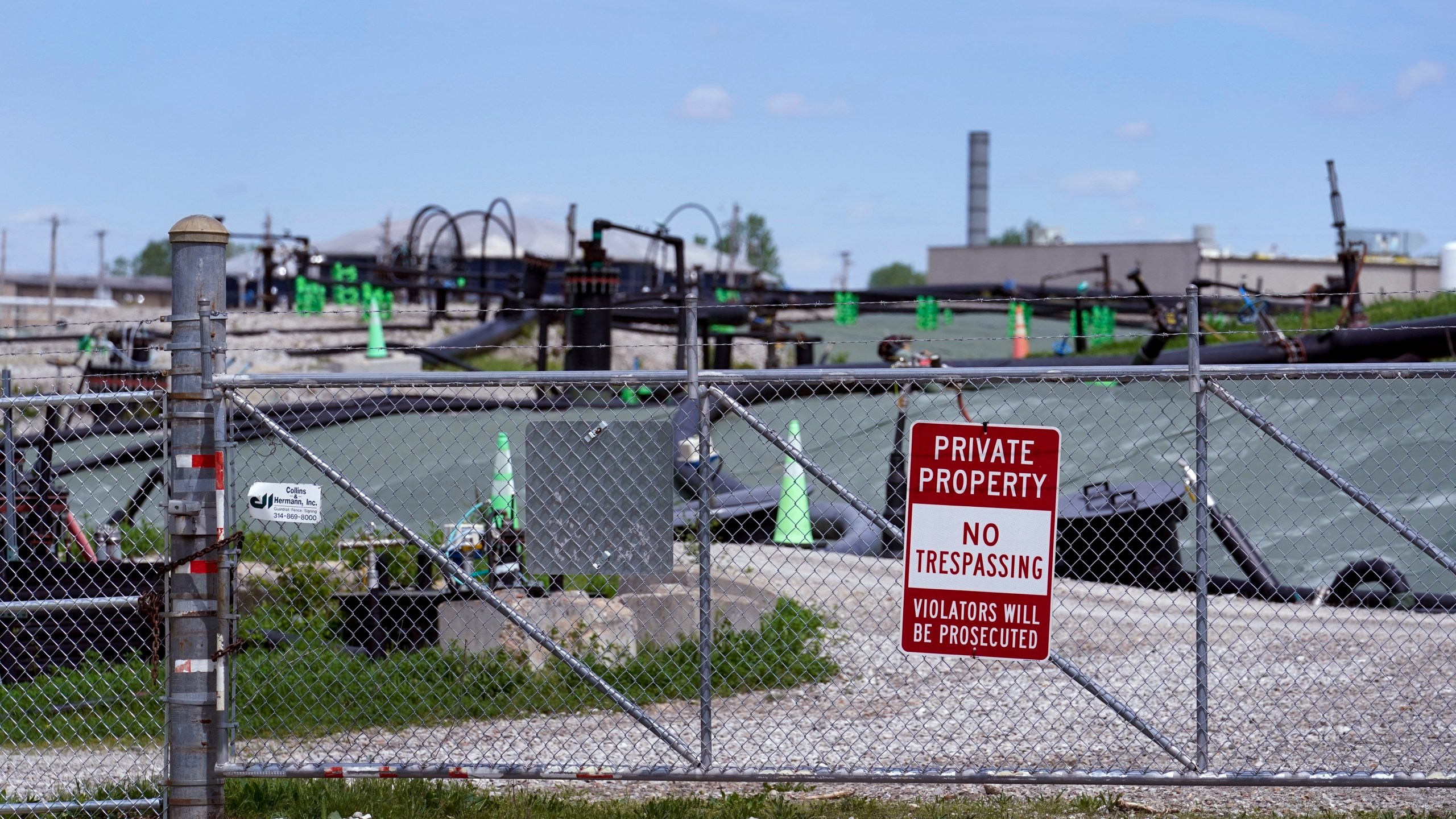 FILE - A no trespassing sign hangs on a fence around the West Lake Landfill Superfund site on Friday, April 21, 2023, in Bridgeton, Mo. The Senate has passed legislation that would compensate Americans exposed to radiation by the government by renewing a law initially passed more than three decades ago. The bill passed the Senate 69-30, with 20 Republicans and all but two Democrats voting in favor. But its prospects in the House are uncertain. (AP Photo/Jeff Roberson, File)