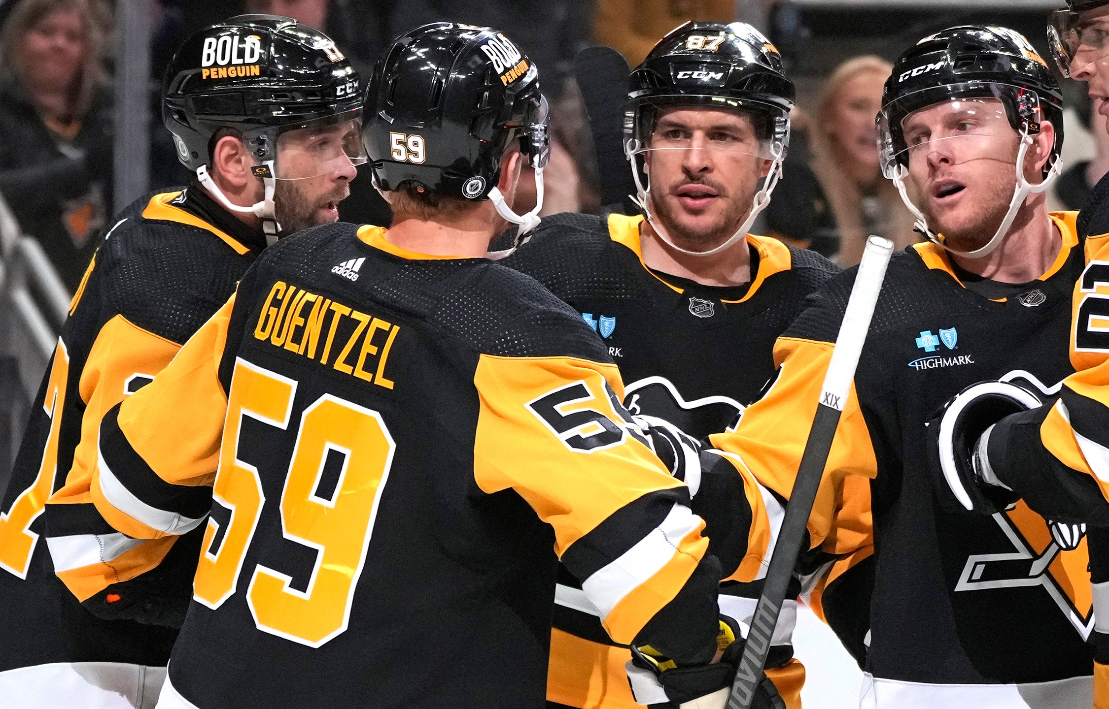 Pittsburgh Penguins' Jake Guentzel (59) celebrates with Bryan Rust, left, Sidney Crosby (87), and Chad Ruhwedel after scoring during the second period of an NHL hockey game against the Florida Panthers in Pittsburgh, Wednesday, Feb. 14, 2024. The Panthers won 5-2. (AP Photo/Gene J. Puskar)