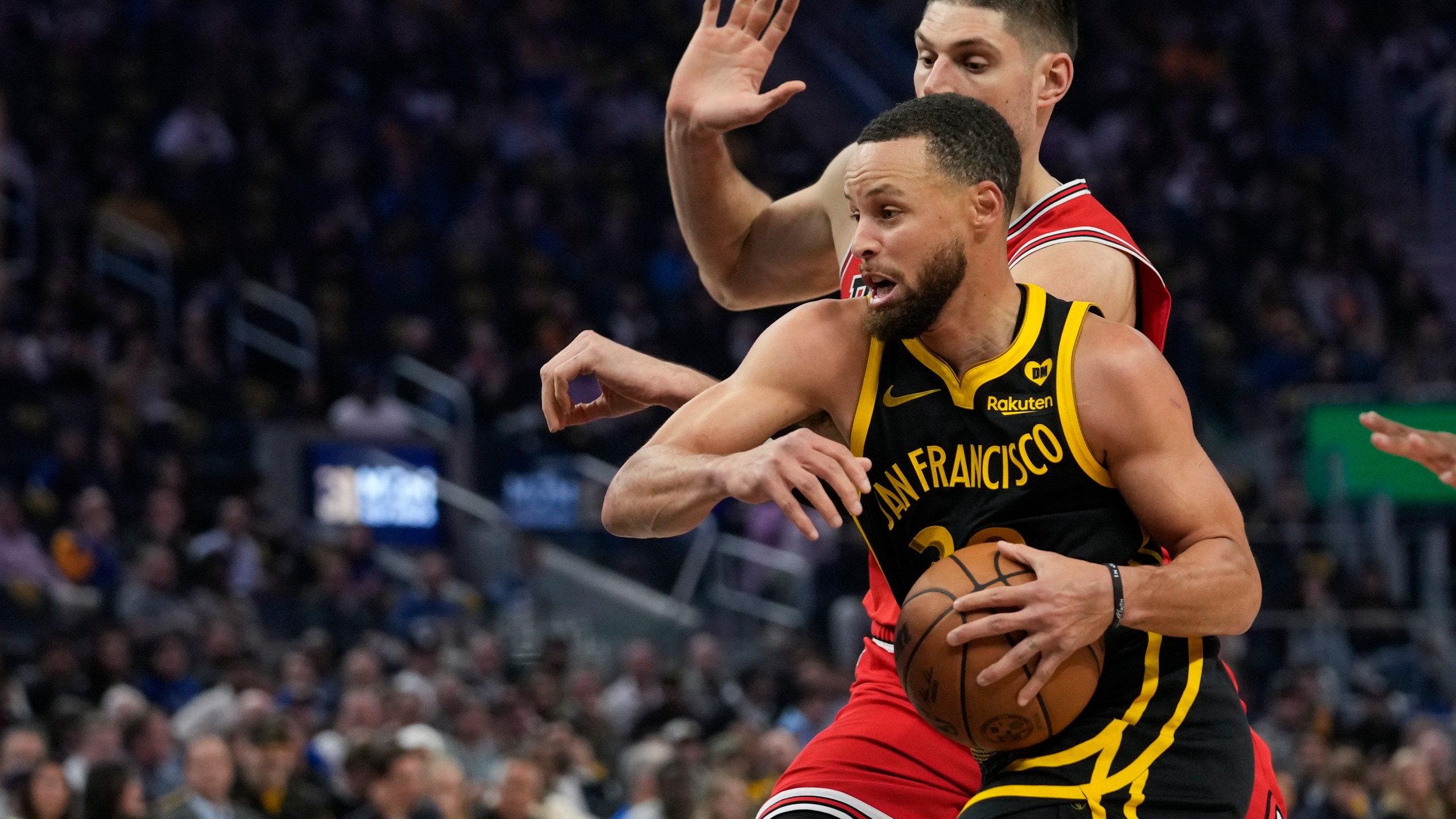 Golden State Warriors guard Stephen Curry drives against Chicago Bulls center Nikola Vucevic during the first half of an NBA basketball game Thursday, March 7, 2024, in San Francisco. (AP Photo/Godofredo A. Vásquez)