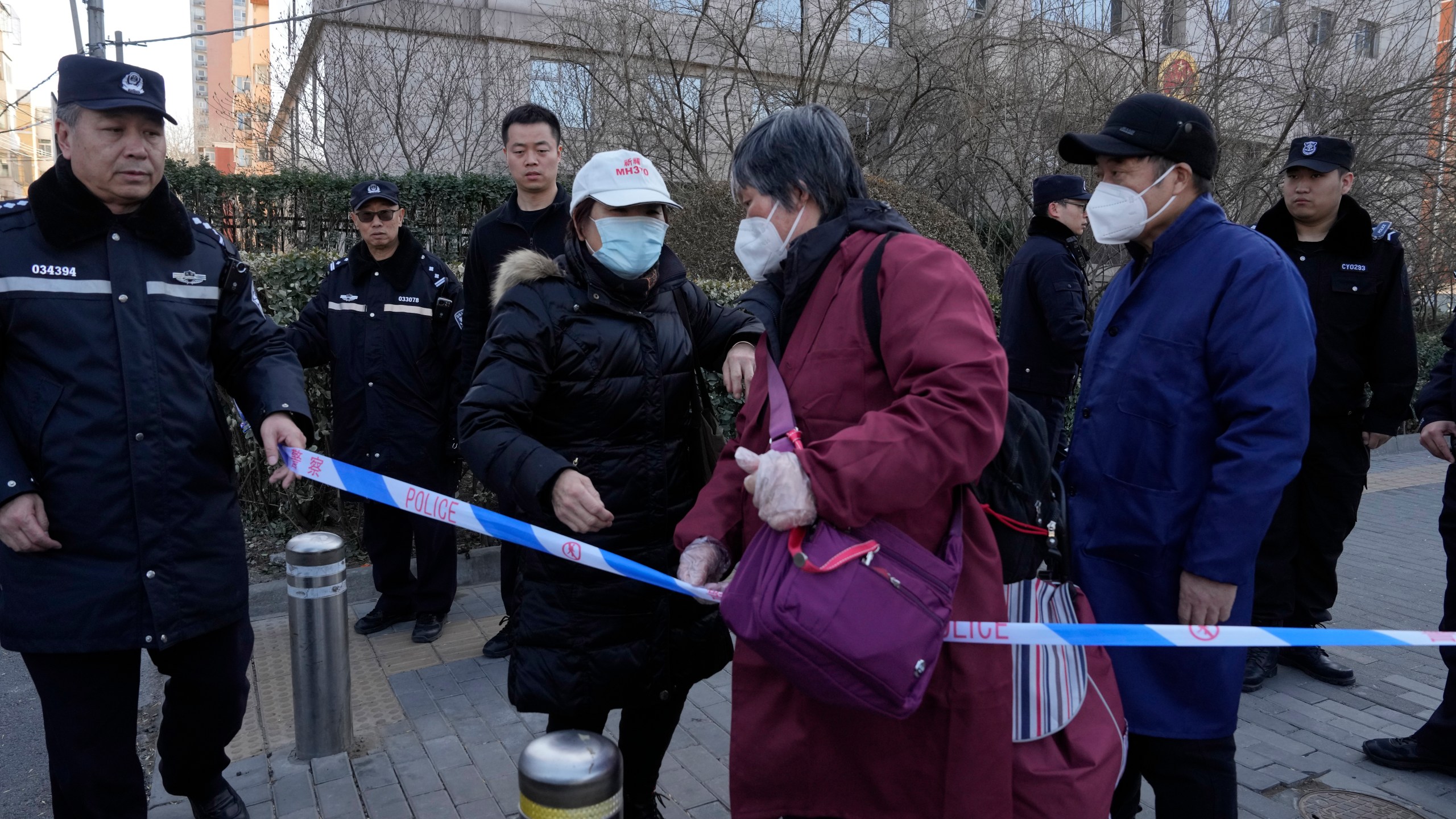 Family members of passengers on board the missing Malaysian Airline MH370 gather outside a court in Beijing, Friday, March 8, 2024. Ten years on, families of passengers on the missing Malaysian Airline flight still are searching for answers. Friday marks the 10th anniversary of the disappearance of the flight, a Boeing 777 left Kuala Lumpur with 239 people on March 8, 2014, but took a sharp turn south and fell off the radar. It never made it to Beijing. (AP Photo/Ng Han Guan)