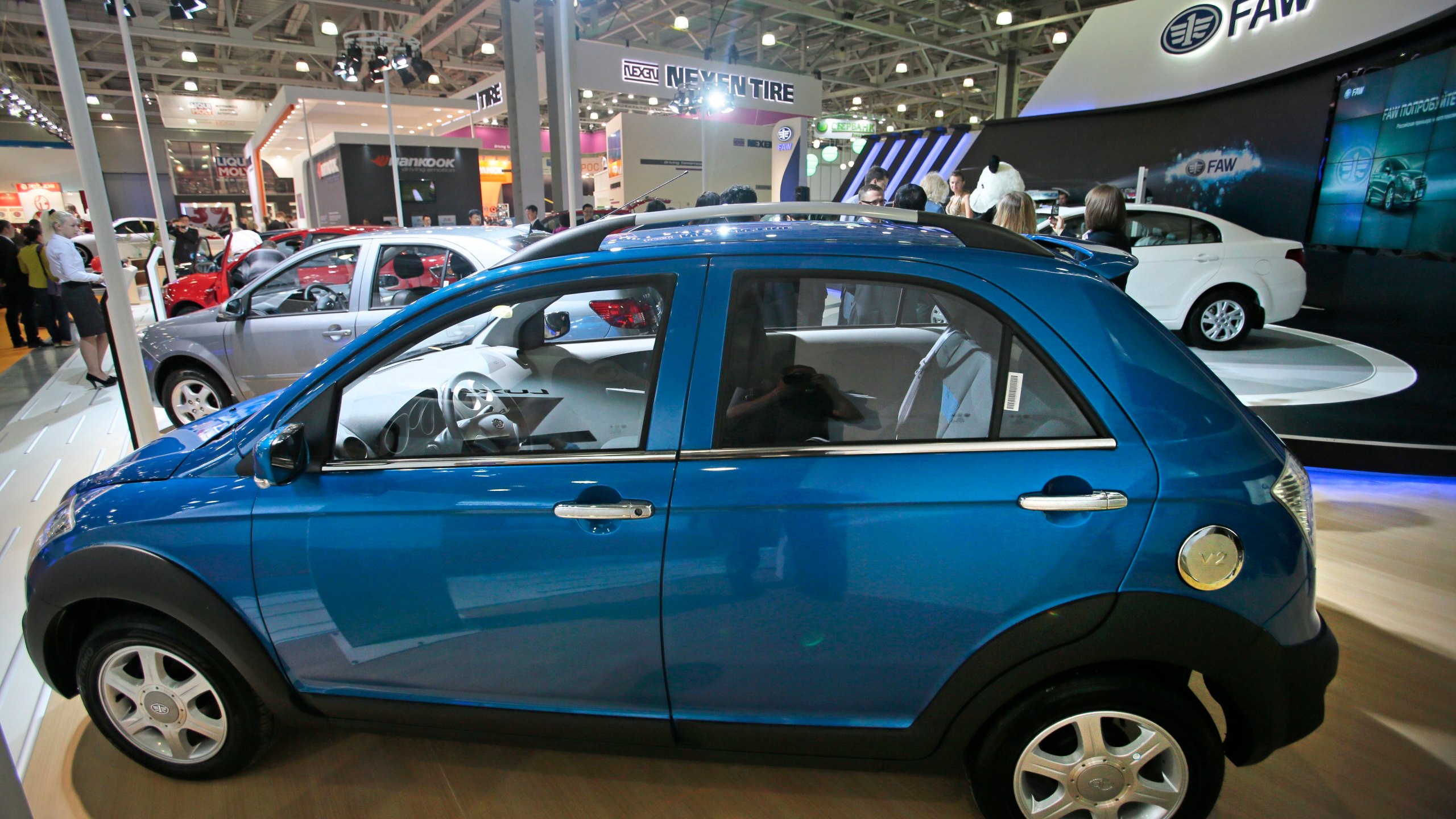 FILE - Chinese FAW V2 car is displayed at the Moscow International Automobile Salon in Moscow, Russia, Friday, Aug. 31, 2012. The divide between China and Europe over the war in Ukraine was on display this week. As a Chinese envoy crisscrossed Europe for talks on ending the war, the Chinese foreign minster trumpeted the export of Chinese cars to Russia and Russian natural gas to China. The sharp rise in China-Russia trade is something the West sees as undermining its sanctions on Russia. (AP Photo/Mikhail Metzel, File)