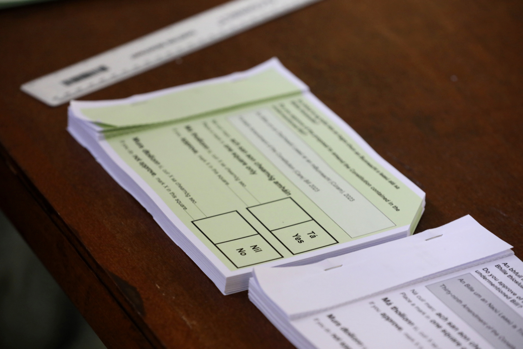 Unmarked voting forms in two languages, English and Irish, for a referendum on the proposed changes to the wording of the Constitution relating to the areas of family and care are seen at Old St Joseph's Gym Hall, in Dublin, Ireland, Friday, March 8, 2024. As the world marks International Women's Day, in Ireland, voters are deciding on Friday whether to change the constitution to remove passages referring to women’s domestic duties and broadening the definition of the family. (Gareth Chaney/PA via AP)
