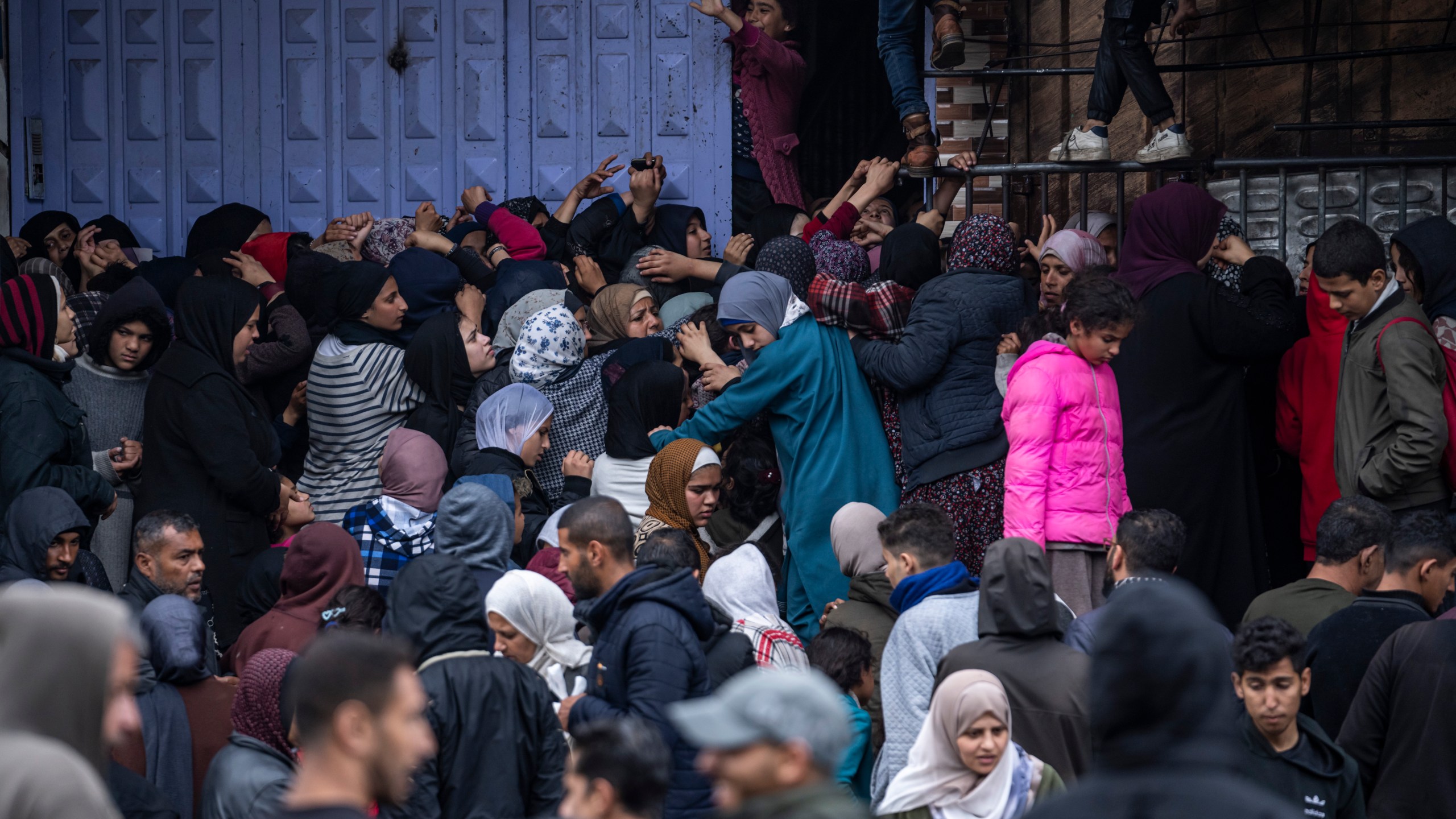 File - Palestinian crowds struggle to buy bread from a bakery in Rafah, Gaza Strip, Sunday, Feb. 18, 2024. (AP Photo/Fatima Shbair, File)