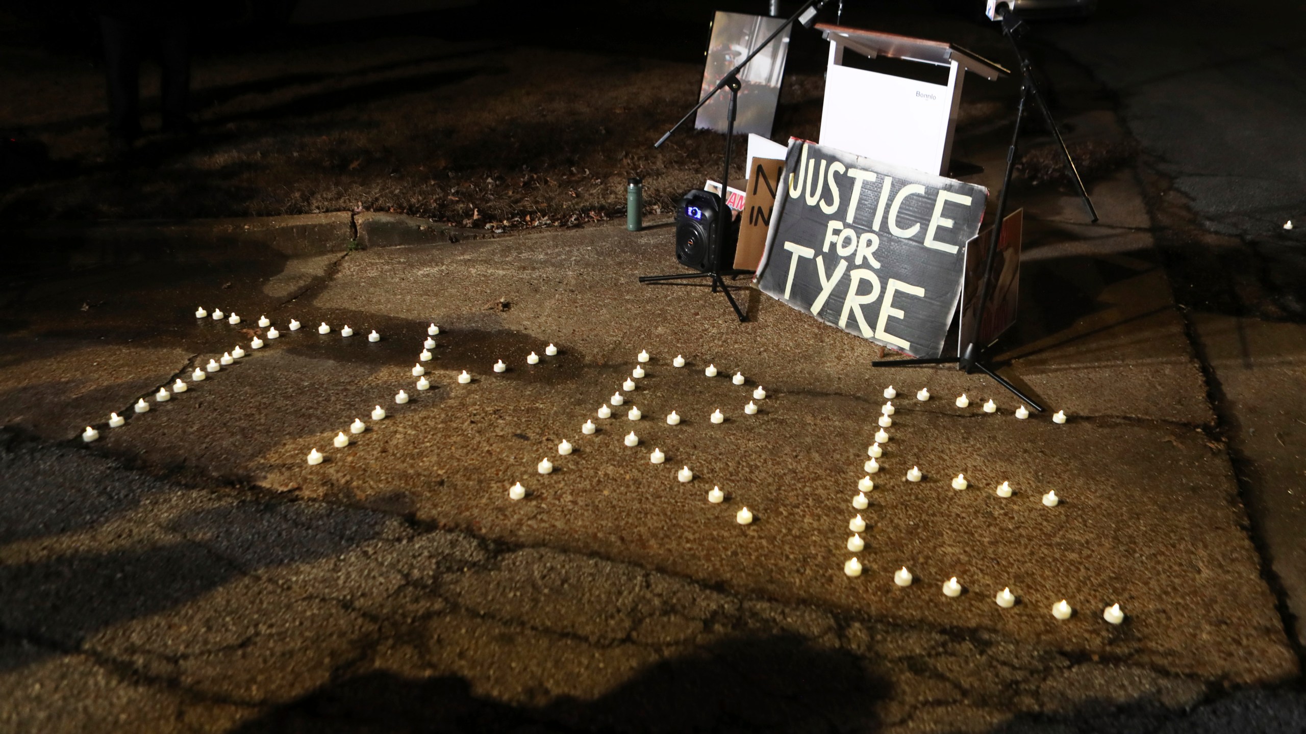 FILE - Candles spell out the name of Tyre Nichols during a candlelight vigil for Nichols on the anniversary of his death, Jan. 7, 2024, in Memphis, Tenn. A judge on Friday, March 8, 2024, indefinitely postponed the state court trial of four former Memphis officers charged with second-degree murder in the fatal beating of Tyre Nichols until after the conclusion of a federal court trial on civil rights violations. (AP Photo/Karen Pulfer Focht, file)