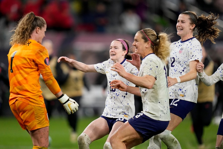 United States goalkeeper Alyssa Naeher, left, celebrates with teammates at the end of the penalty shootout in a CONCACAF Gold Cup women's soccer tournament semifinal match against Canada, Wednesday, March 6, 2024, in San Diego. (AP Photo/Gregory Bull)