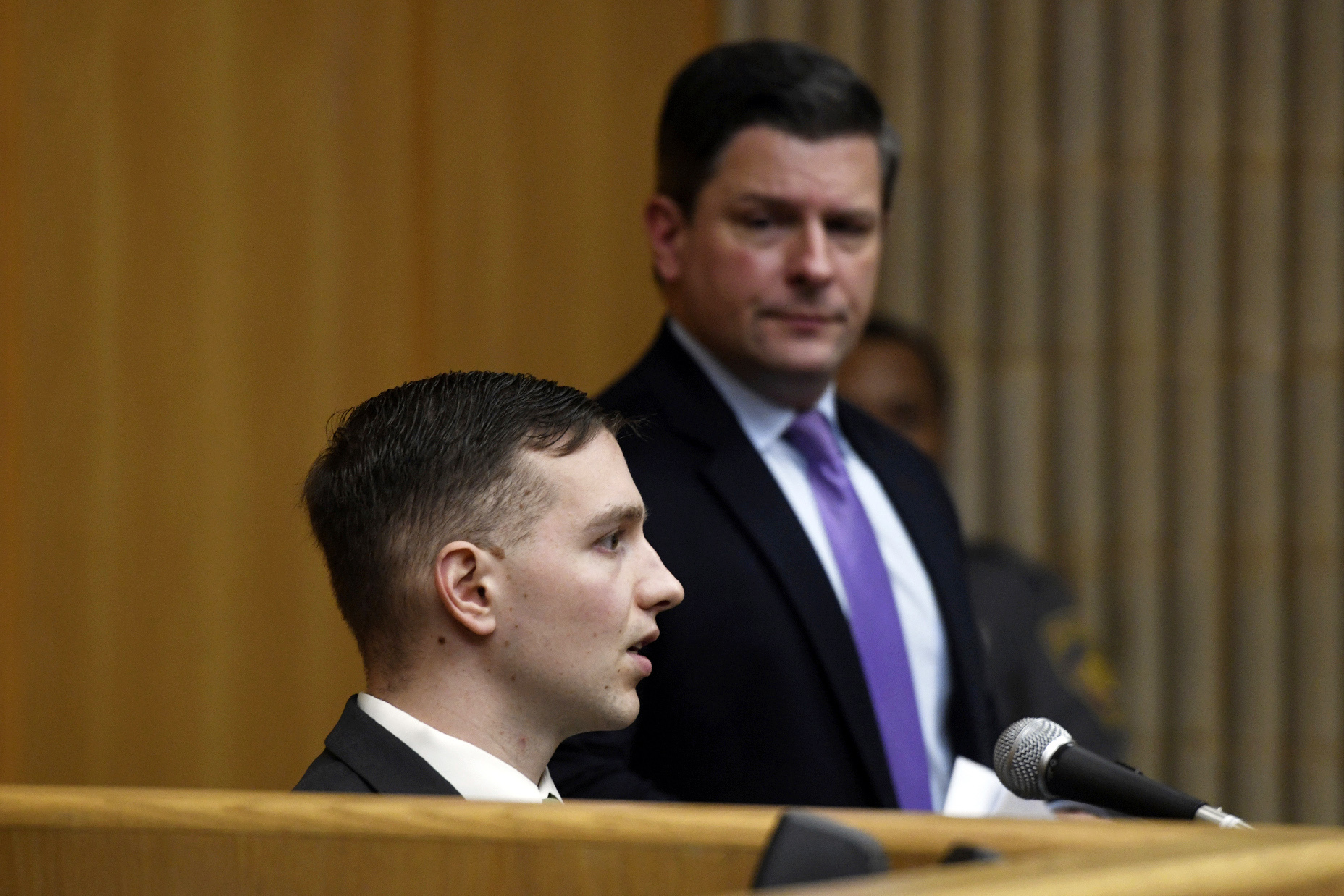 Connecticut State Trooper Brian North, foreground,a nswers questions from his defense attorney Frank Riccio as he testifies during his trial in Connecticut Superior Court, Friday, March 8, 2024, in Milford, Conn. North is charged with first-degree manslaughter for shooting 19-year-old Mubarak Soulemane in January 2020 in West Haven after a chase from Norwalk on Interstate 95. (Ned Gerard/Hearst Connecticut Media via AP, Pool)