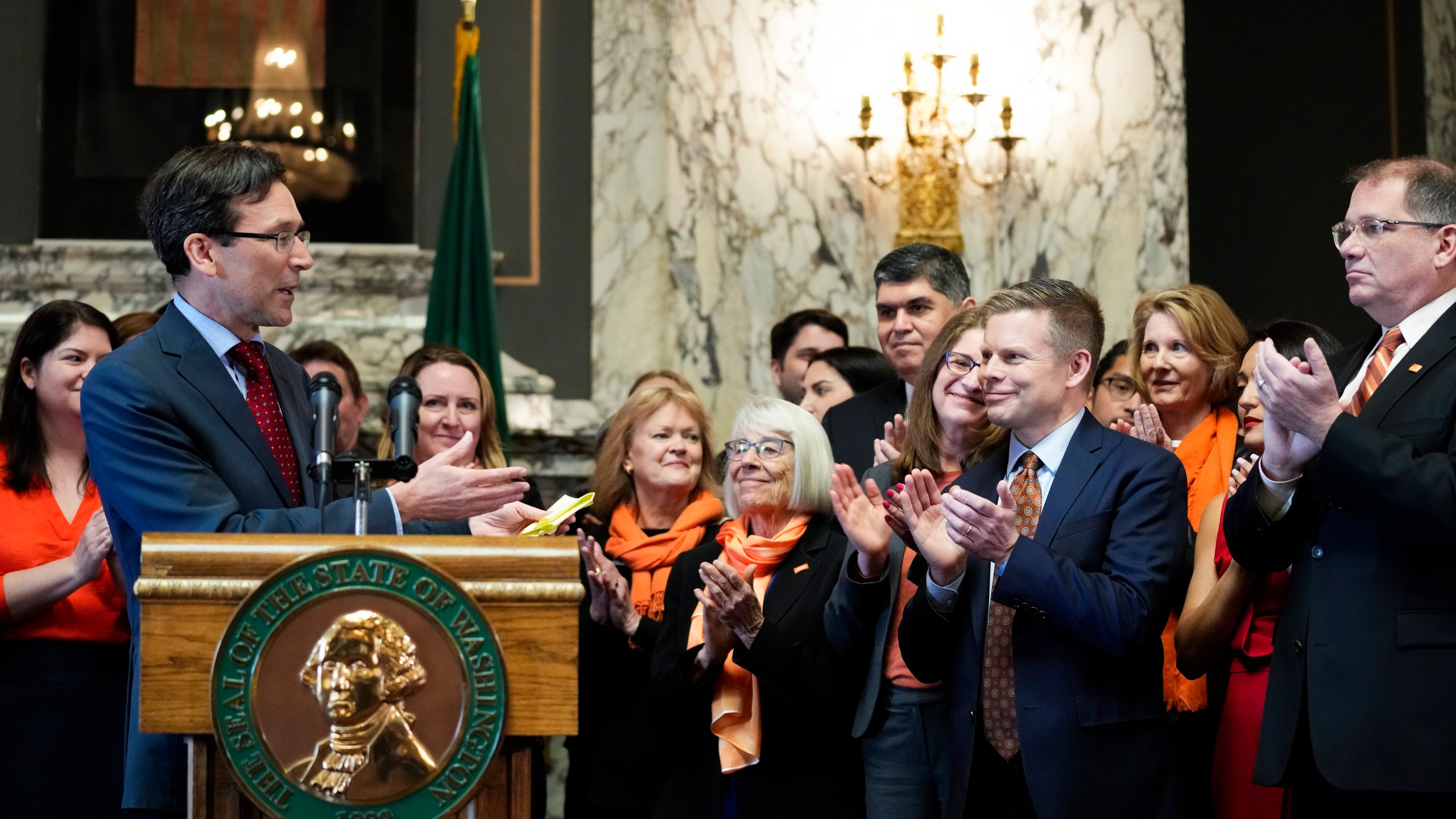 FILE -Washington Attorney General Bob Ferguson introduces Sen. Jamie Pedersen, D-Seattle, second from right, after making remarks Tuesday, April 25, 2023, at the Capitol in Olympia, Wash. A federal judge on Friday, March 8, 2024 rejected a challenge to a Washington state law that cleared the way for lawsuits against the gun industry in certain cases. The measure was one of three bills signed by Democratic Gov. Jay Inslee last year seeking to address gun violence. (AP Photo/Lindsey Wasson, File)