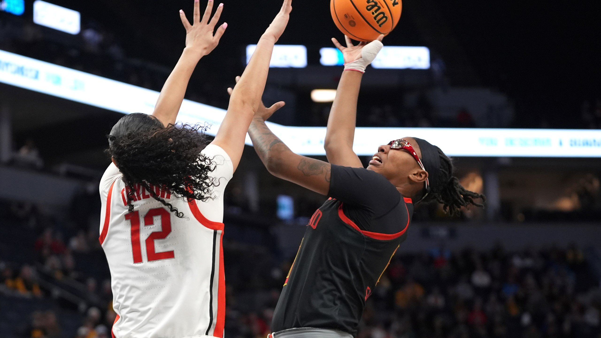 Maryland guard Shyanne Sellers shoots over Ohio State guard Celeste Taylor (12) during the first half of an NCAA college basketball game in the quarterfinals of the Big Ten women's tournament Friday, March 8, 2024, in Minneapolis. (AP Photo/Abbie Parr)