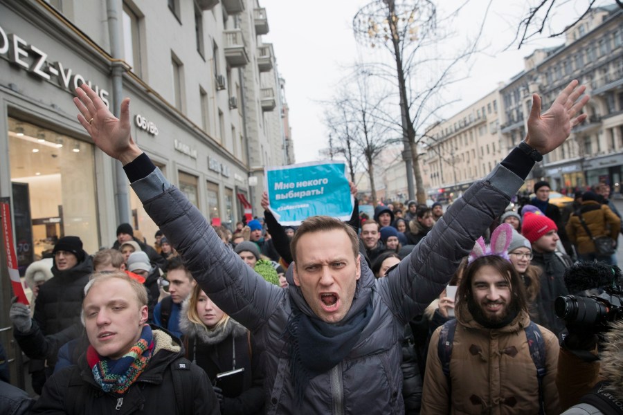 FILE - Russian opposition leader Alexei Navalny, center, attends a rally in Moscow on Sunday, Jan. 28, 2018. During his 24-year rule, Russian President Vladimir Putin has gone from tolerating dissent to suppressing any challenger. Most Russian opposition politicians are in prison or exile. (AP Photo/Evgeny Feldman, File)