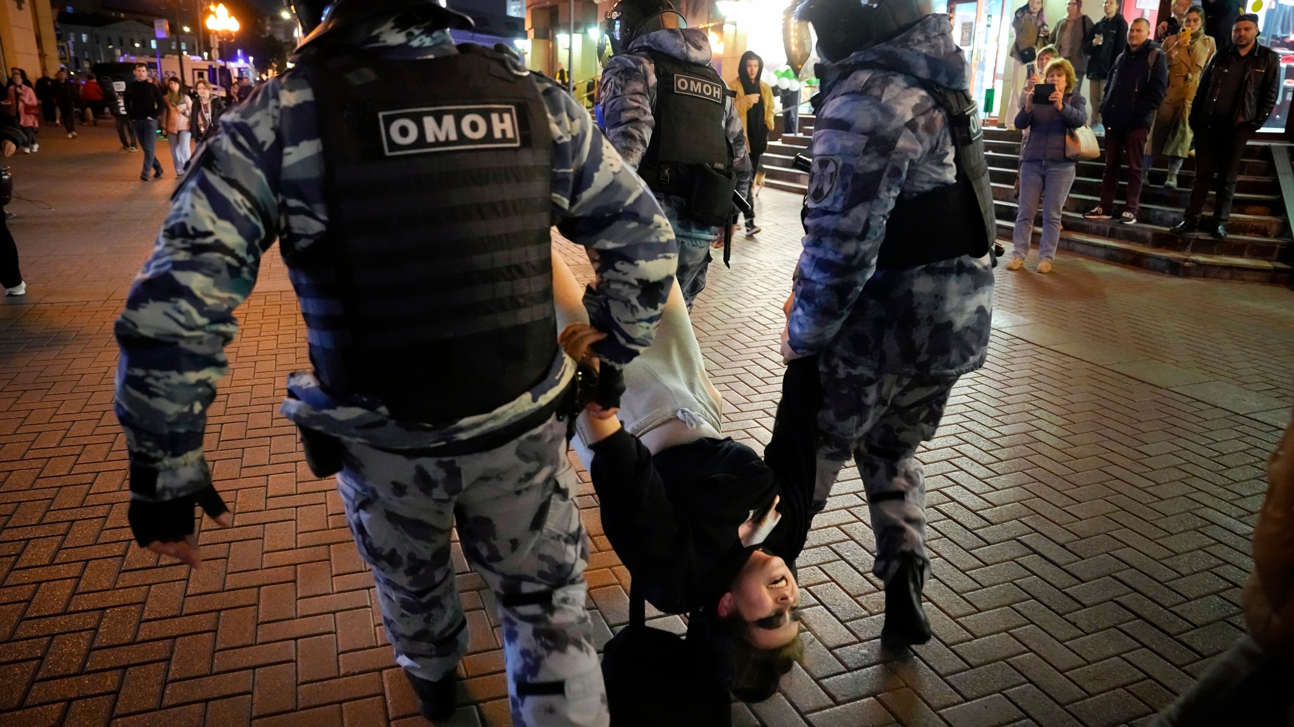 FILE - Riot police detain a demonstrator during a protest against mobilization in Moscow on Wednesday, Sept. 21, 2022. In the last two years, ordinary Russians have been increasingly swept up in an unprecedented government crackdown, together with opposition politicians, independent journalists and human rights activists. (AP Photo, File)