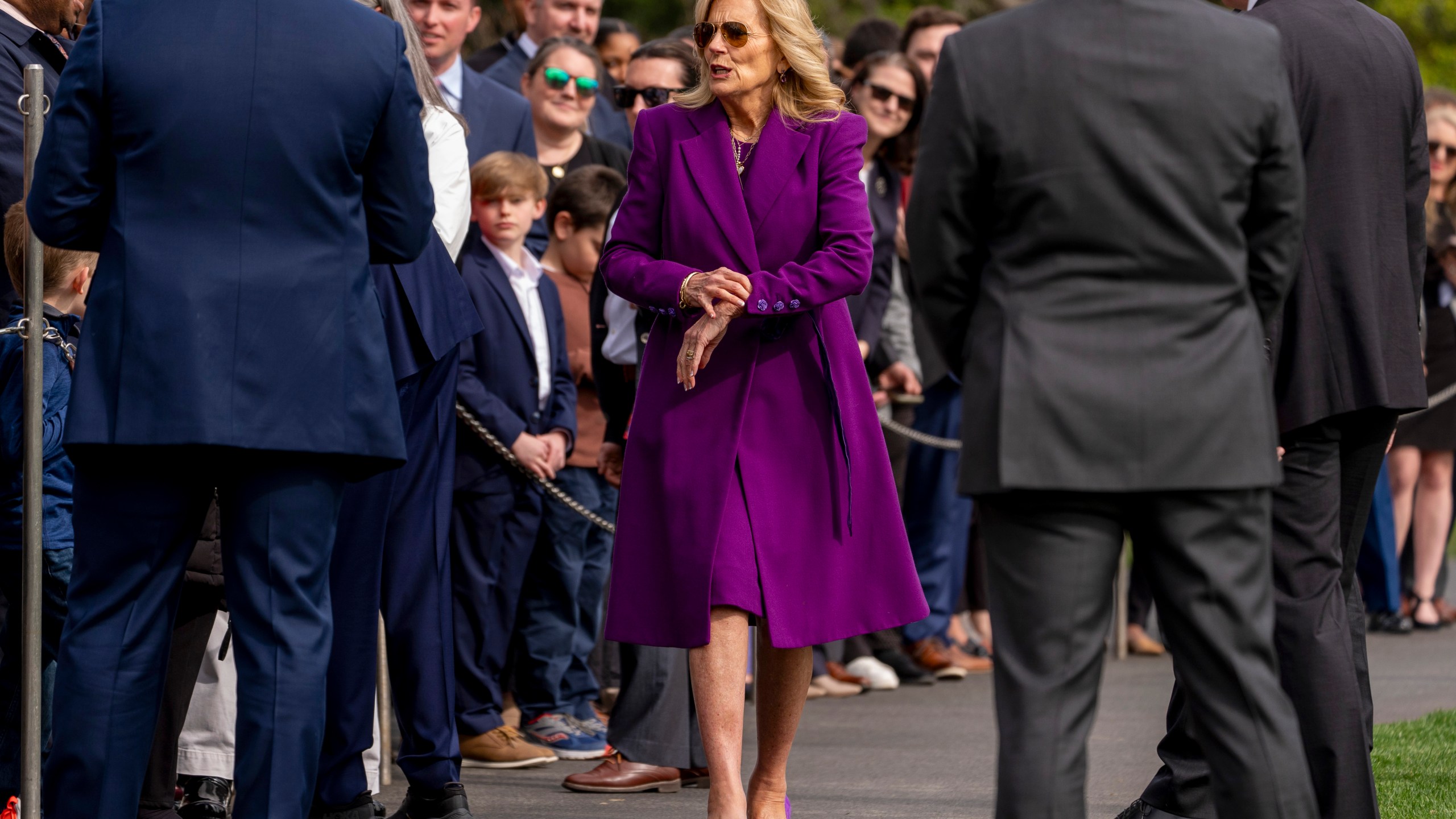 First lady Jill Biden checks her watch as President Joe Biden, not pictured, greets guests on the South Lawn before boarding Marine One at the White House in Washington, Friday, March 8, 2024, for a short trip to Andrews Air Force Base, Md., and then on to Philadelphia for a campaign event. (AP Photo/Andrew Harnik)
