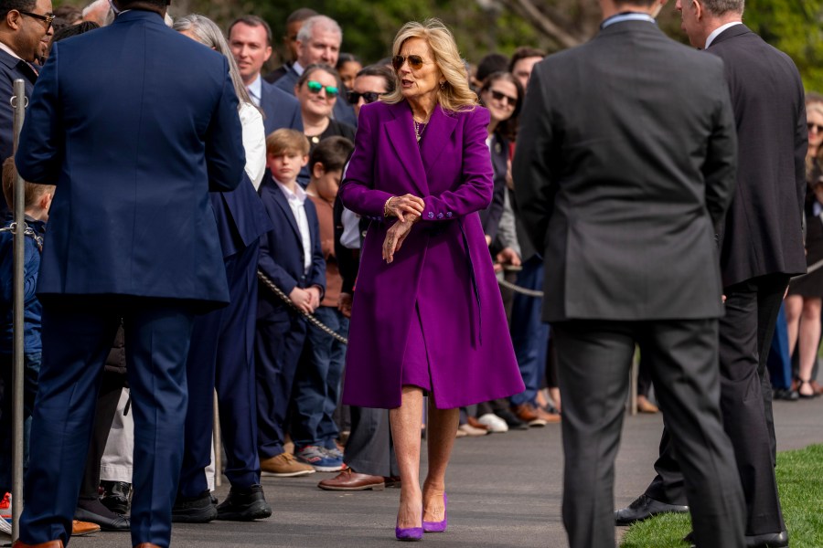 First lady Jill Biden checks her watch as President Joe Biden, not pictured, greets guests on the South Lawn before boarding Marine One at the White House in Washington, Friday, March 8, 2024, for a short trip to Andrews Air Force Base, Md., and then on to Philadelphia for a campaign event. (AP Photo/Andrew Harnik)