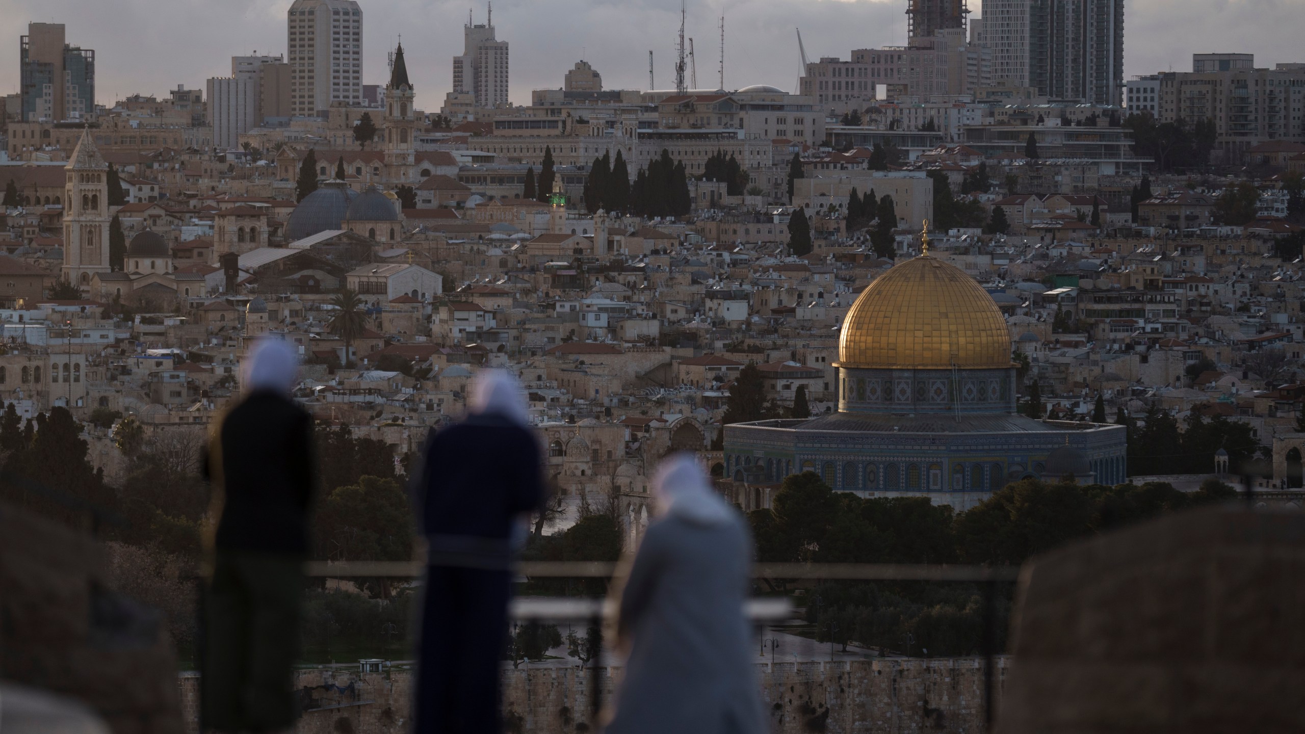 FILE - Muslim women visit the Mount of Olives, overlooking the Dome of the Rock at the Al Aqsa Mosque compound in the Old City of Jerusalem, Thursday, March 7, 2024. Restrictions put in place amid the Israel-Hamas war have left many Palestinians concerned they might not be able to pray at the mosque, which is revered by Muslims. (AP Photo/Leo Correa, File)