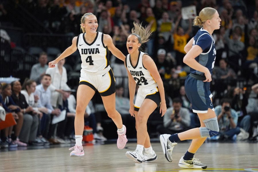 Iowa guard Gabbie Marshall (24) celebrates next to guard Kylie Feuerbach (4) after making a 3-point basket during the first half of an NCAA college basketball quarterfinal game against Penn State at the Big Ten women's tournament Friday, March 8, 2024, in Minneapolis. (AP Photo/Abbie Parr)