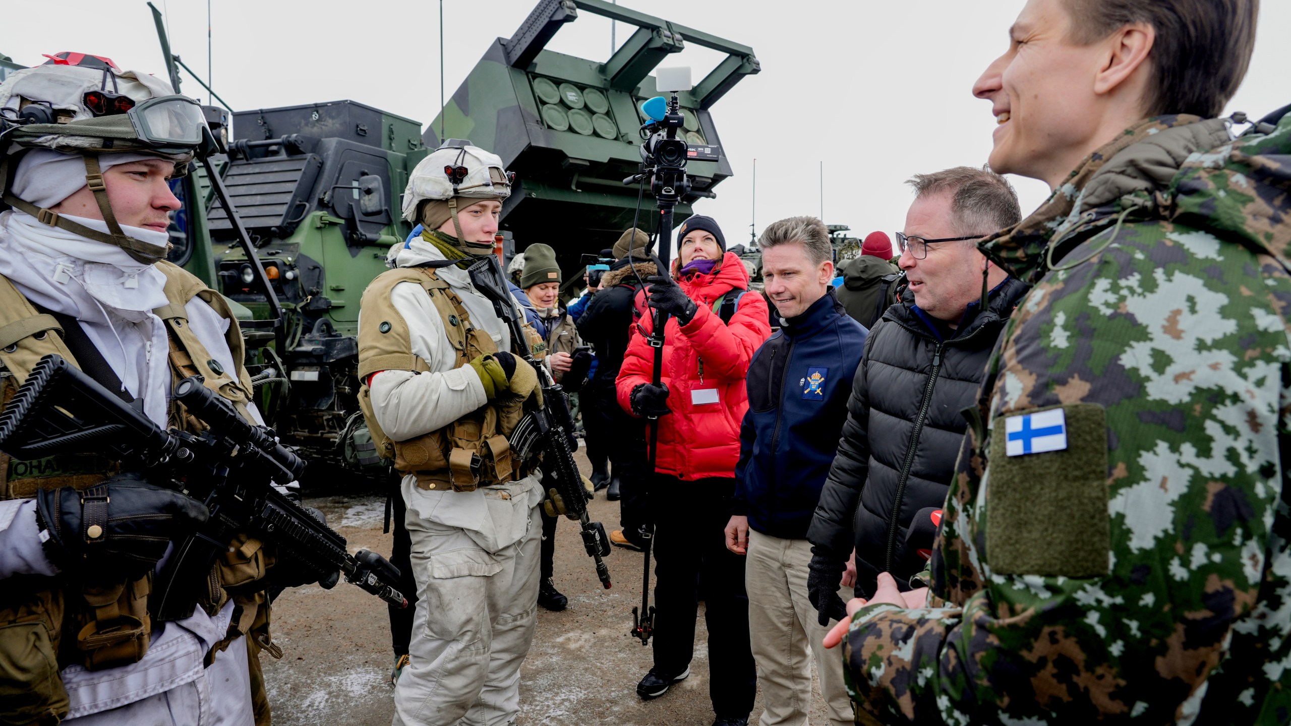 Sweden's Defense Minister Pål Jonson, centre right, Norway's Defense Minister Bjørn Arild Gram, second right and Finland's Defense Minister Antti Häkkänen react as Norwegian, Swedish and Finnish forces meet on the border between the three countries , during a NATO training exercise, in Kautokeino, Norway, Saturday, March 9, 2024, Large NATO drills in the frigid fjords of northern Norway may be just war games meant to hone the skills of the newly expanded 32-nation military alliance in the event of conflict. But for the troops taking part, they are very real. (Heiko Junge /NTB Scanpix via AP)