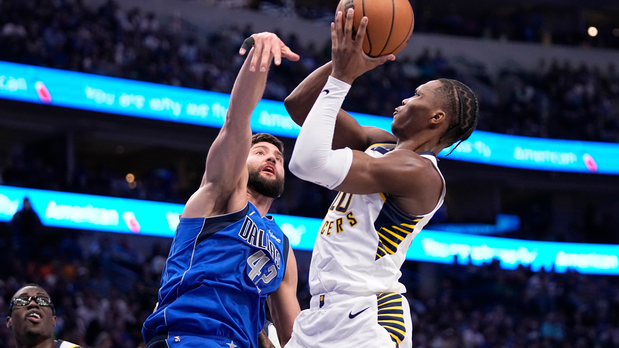 Indiana Pacers guard Bennedict Mathurin (00) shoots against Dallas Mavericks' Maxi Kleber (42) during the first half of an NBA basketball game Tuesday, March 5, 2024, in Dallas. (AP Photo/Tony Gutierrez)