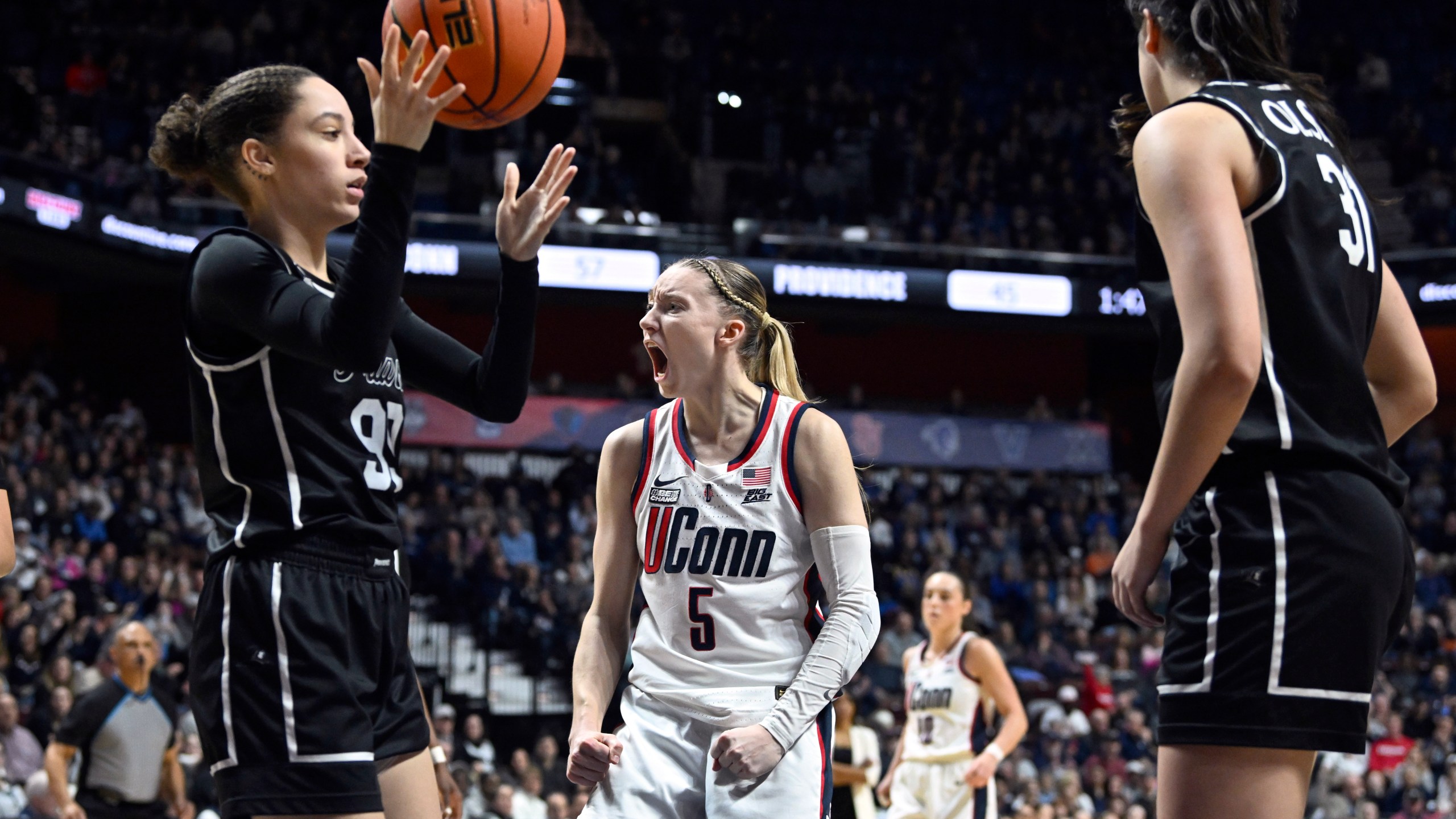 UConn guard Paige Bueckers (5) reacts to drawing a foul against Providence during an NCAA college basketball game in the quarterfinals of the a Big East tournament, Saturday, March 9, 2024, at the Mohegan Sun Arena in Uncasville, Conn. (Cloe Poisson/Hartford Courant via AP)