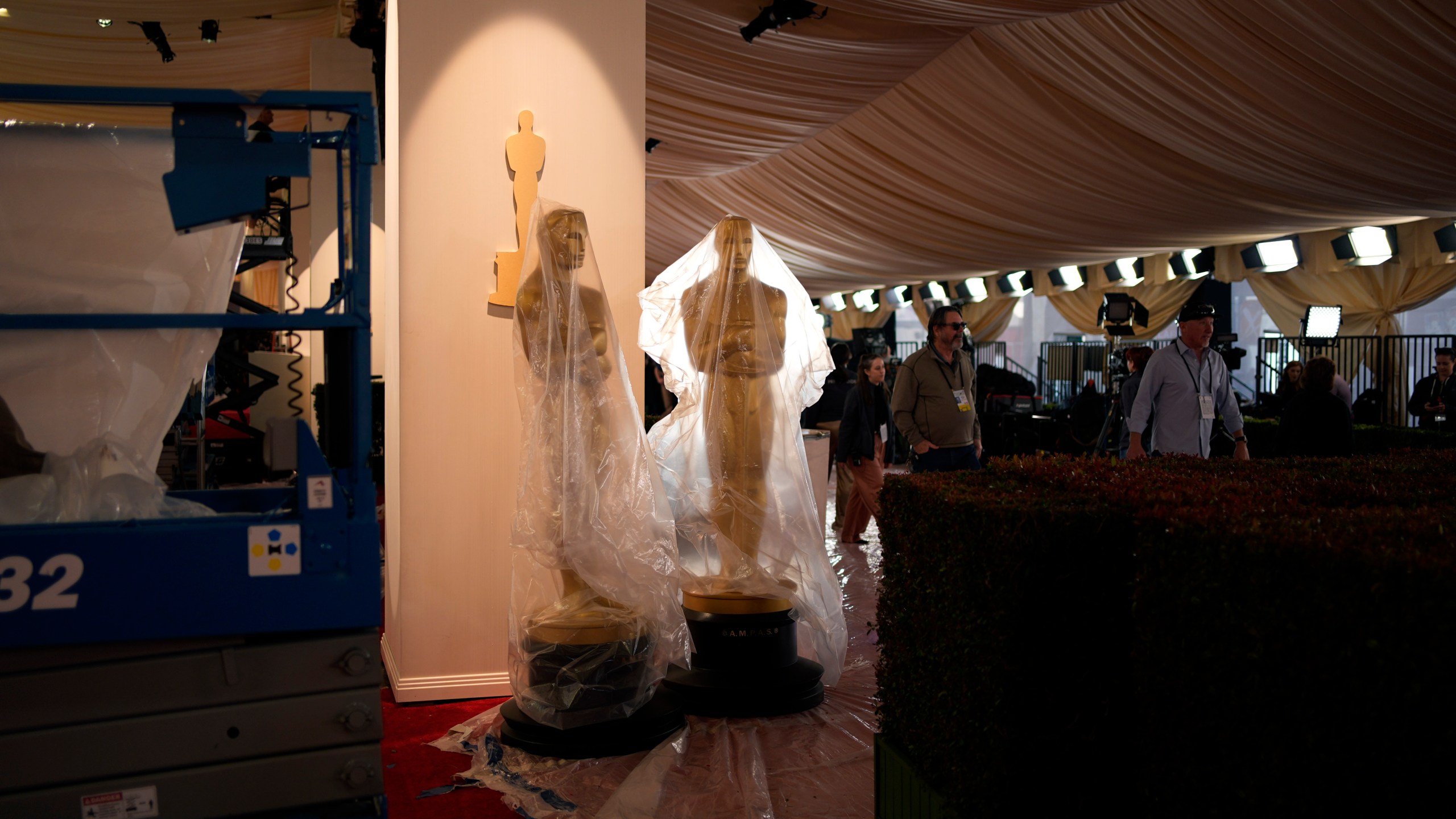 Plastic covers Oscars statues along the red carpet ahead of the 96th Academy Awards Friday, March 8, 2024, in Los Angeles. (AP Photo/John Locher)