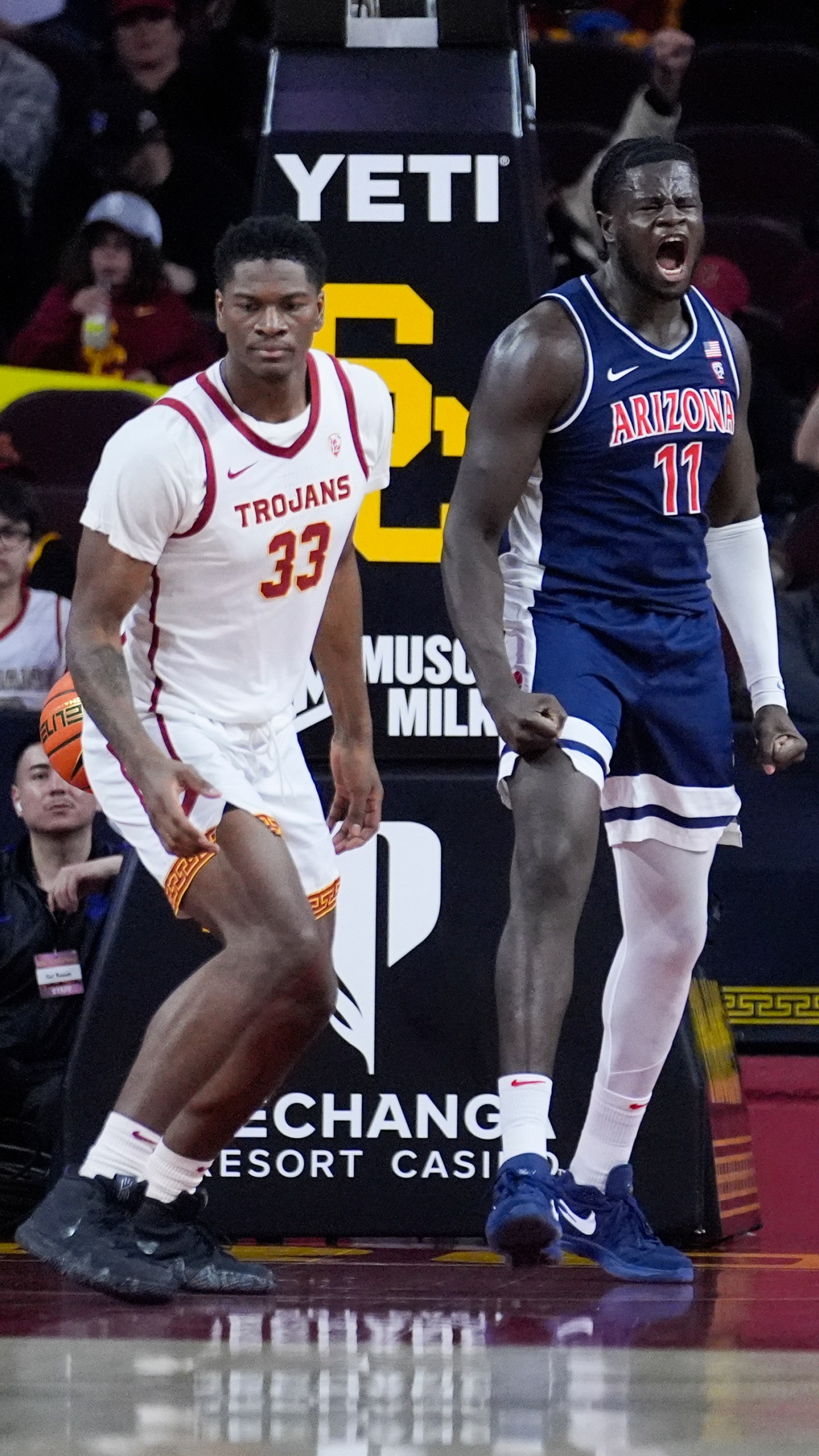 Arizona center Oumar Ballo (11) celebrates after scoring next to Southern California forward Kijani Wright (33) during the first half of an NCAA college basketball game Saturday, March 9, 2024, in Los Angeles. (AP Photo/Marcio Jose Sanchez)