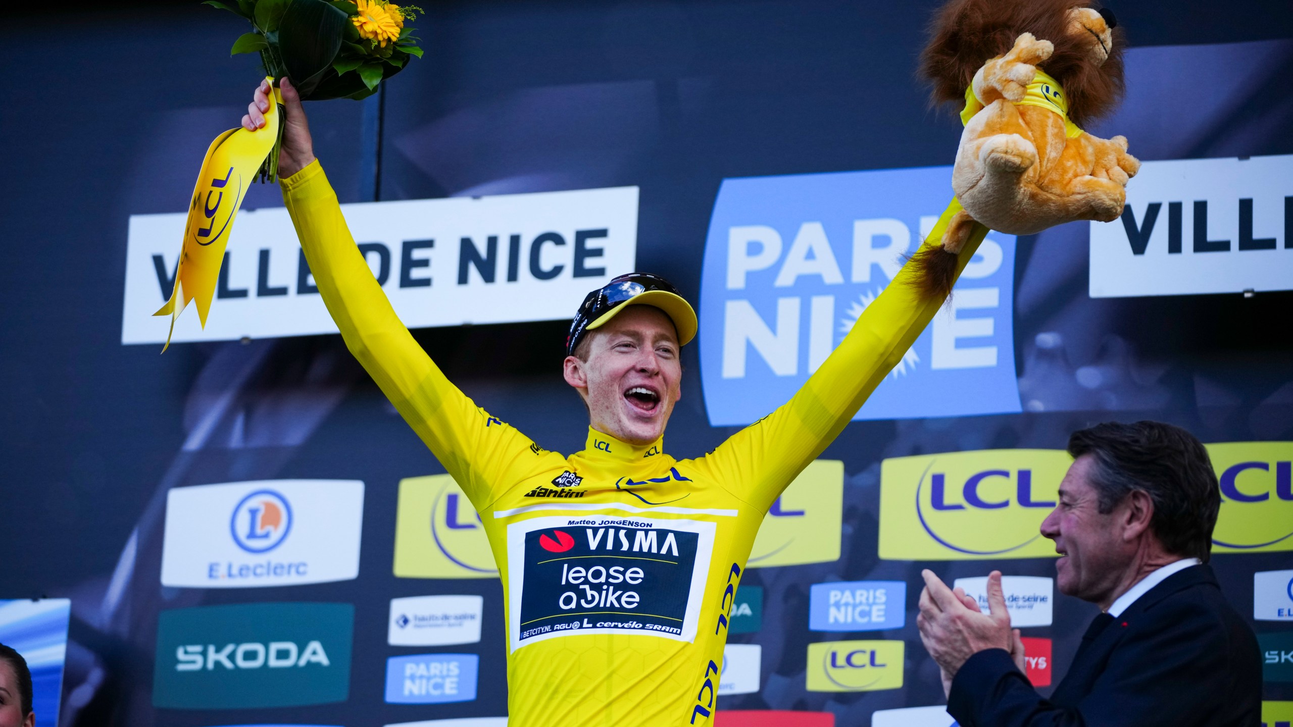 Matteo Jorgenson of The United States wearing the overall leaders jersey celebrates on the podium after winning the general classification of the Paris-Nice cycling race in Nice, Sunday, March 10, 2024. (AP Photo/Daniel Cole)
