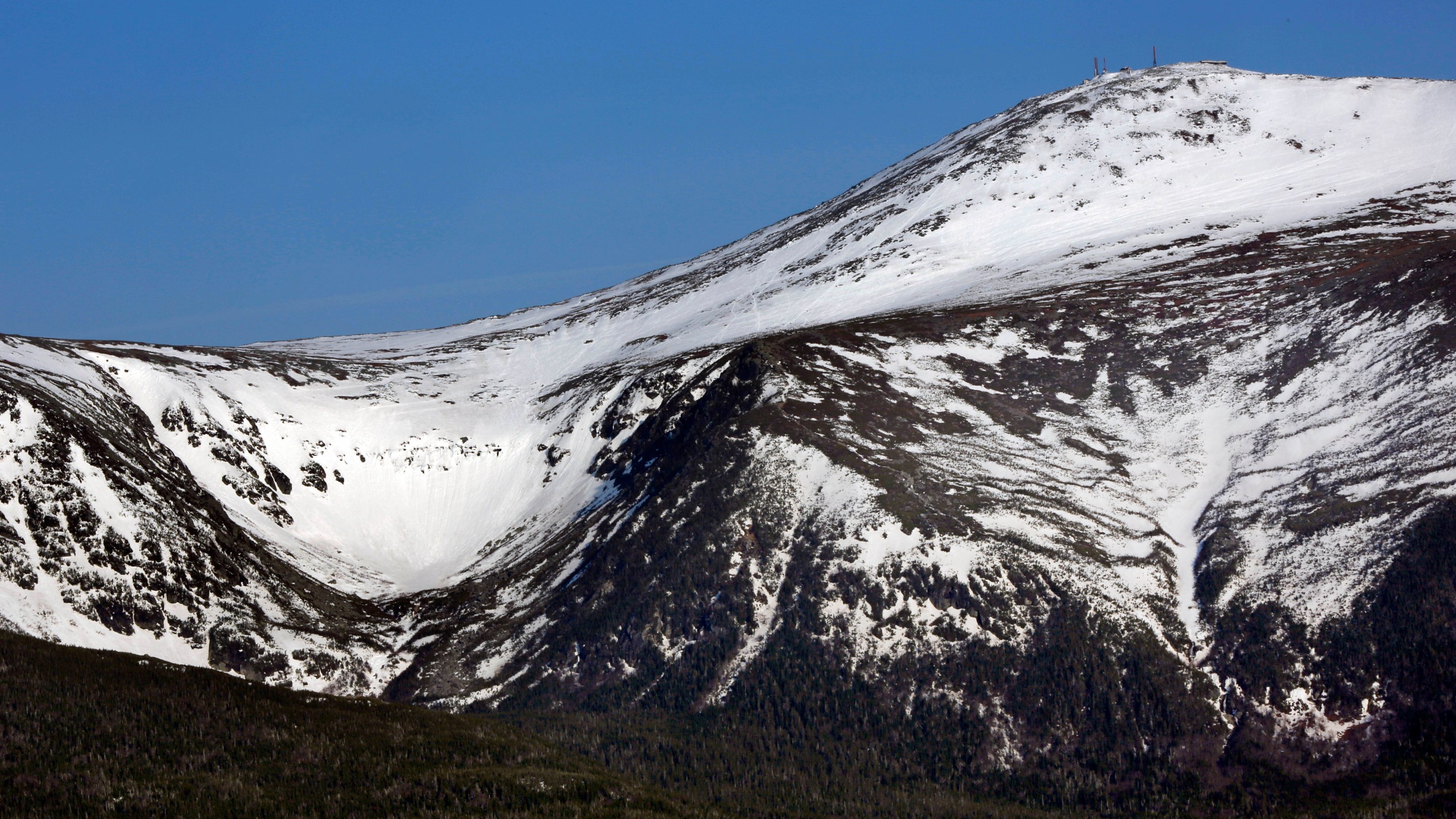 FILE - Tuckerman Ravine is seen at left, about one mile below the summit of 6,288-foot Mount Washington, in New Hampshire, Monday, May 4, 2015. (AP Photo/Robert F. Bukaty, File)