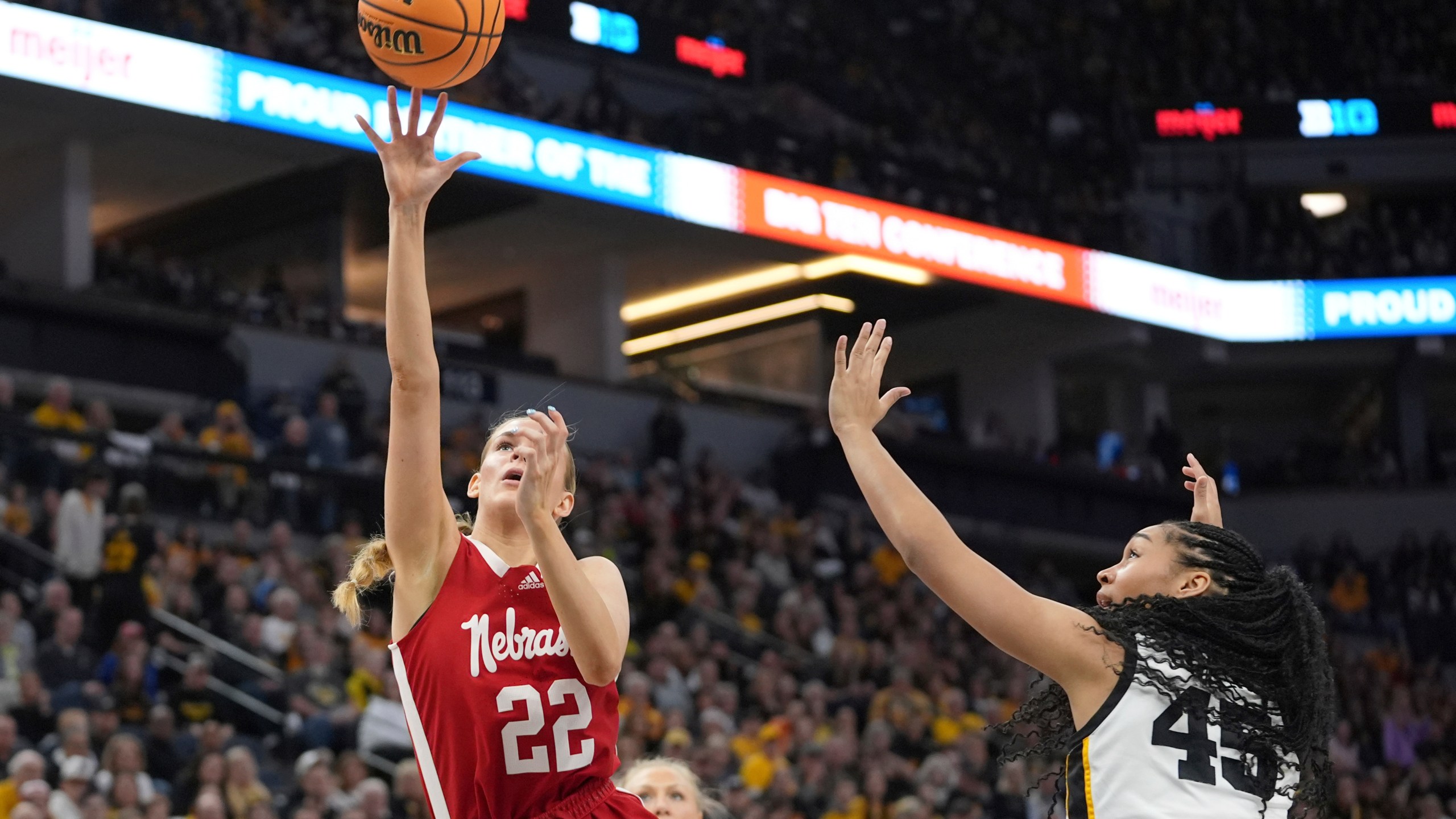 Nebraska forward Natalie Potts (22) shoots against Iowa forward Hannah Stuelke (45) during the first half of an NCAA college basketball game in the final of the Big Ten women's tournament Sunday, March 10, 2024, in Minneapolis. (AP Photo/Abbie Parr)