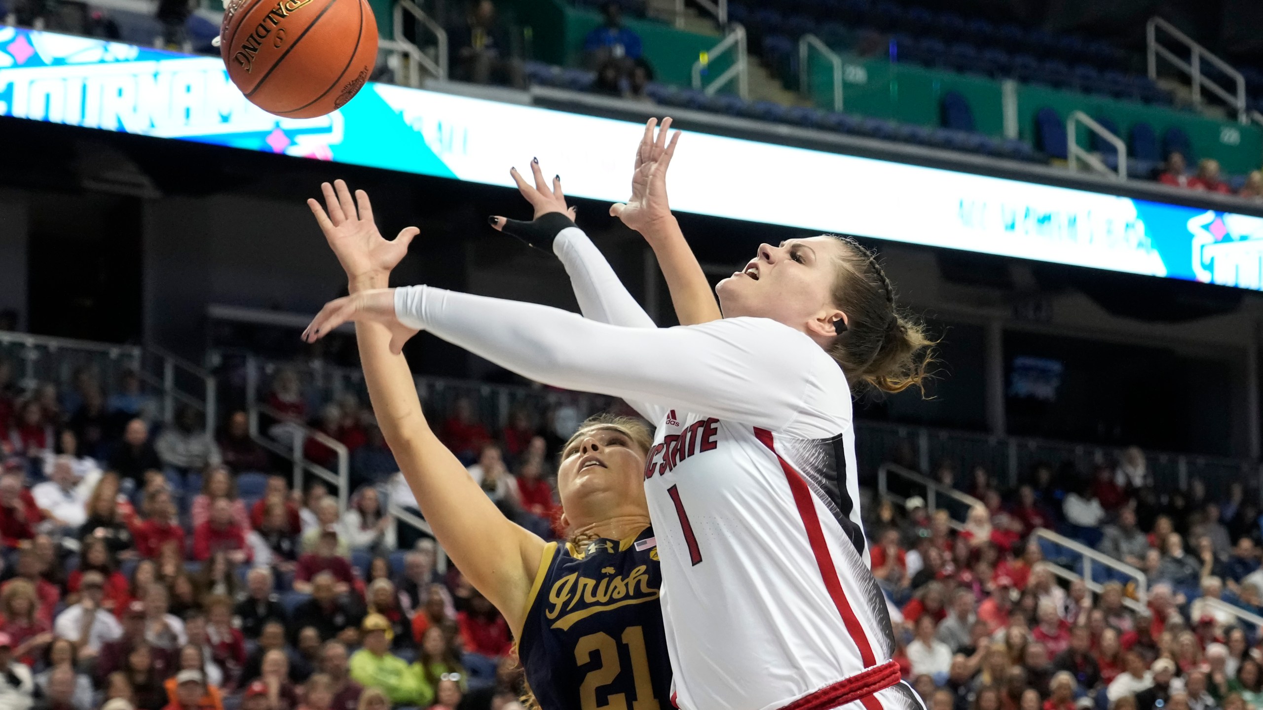 NC State's River Baldwin (1) shoots giants Notre Dame's Maddy Westbeld (21) during the first half of an NCAA basketball game for the Women's Atlantic Coast Conference championship in Greensboro, N.C., Sunday, March 10, 2024. (AP Photo/Chuck Burton)