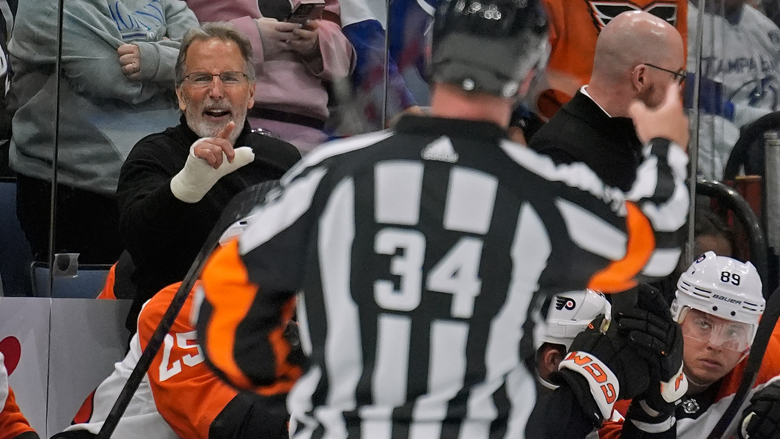 Philadelphia Flyers head coach John Tortorella, left, yells at referee Brad Meier (34) after being kicked out the game against the Tampa Bay Lightning during the first period of an NHL hockey game Saturday, March 9, 2024, in Tampa, Fla. (AP Photo/Chris O'Meara)