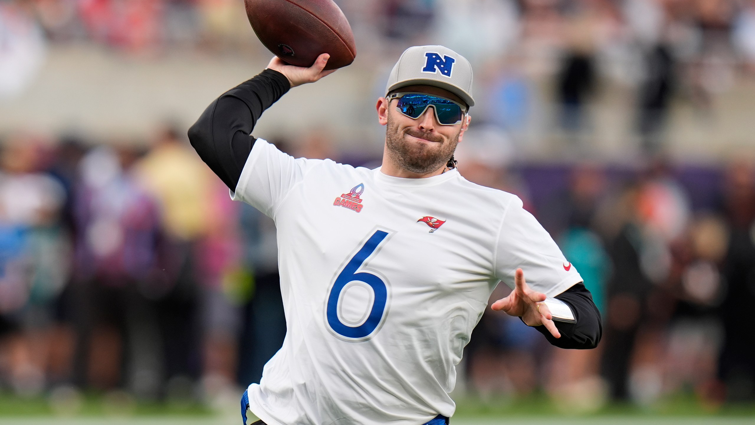 FILE - NFC quarterback Baker Mayfield, of the Tampa Bay Buccaneers, throws against the AFC during the flag football event at the NFL Pro Bowl football game, Sunday, Feb. 4, 2024, in Orlando. Mayfield is staying with the Tampa Bay Buccaneers after agreeing to a three-year contract worth up to $115 million, a person familiar with the deal told The Associated Press on Sunday, March 10, 2024. (AP Photo/Chris O'Meara, File)
