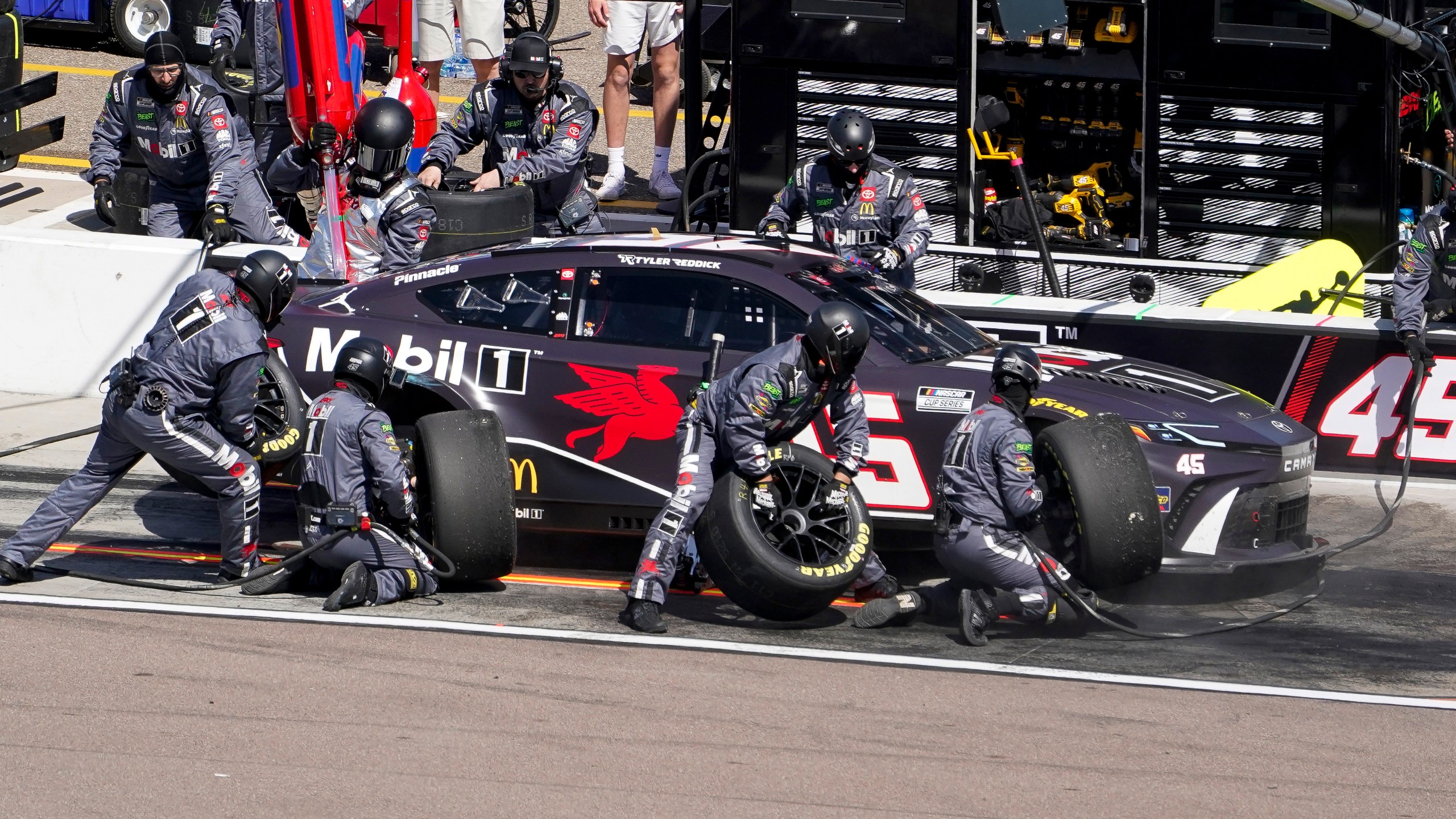 Tyler Reddick's pit crew works on his car during a NASCAR Cup Series auto race at Phoenix Raceway, Sunday, March 10, 2024, in Avondale, Ariz. (AP Photo/Darryl Webb)