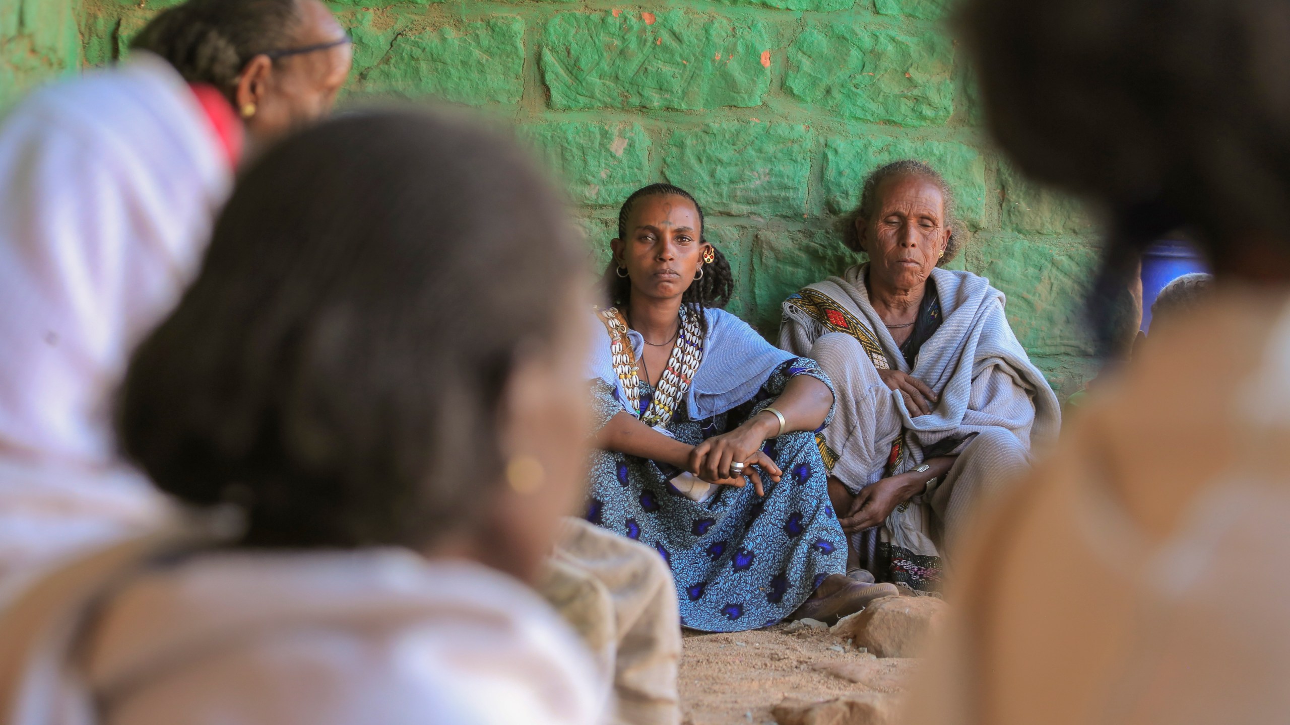 Ethiopian women gather at a community meeting in Mai Mekden, in the Tigray region of northern Ethiopia, on Monday, Feb. 26, 2024. Once-lush fields lie barren. Mothers, faces etched with worry, watch helplessly as their children weaken from malnutrition. The Ethiopian region of Tigray is peaceful but war’s effects linger, compounded by drought and a level of aid mismanagement that caused the U.N. and the U.S. to temporarily suspend deliveries last year. (AP Photo/Amir Aman Kiyaro)