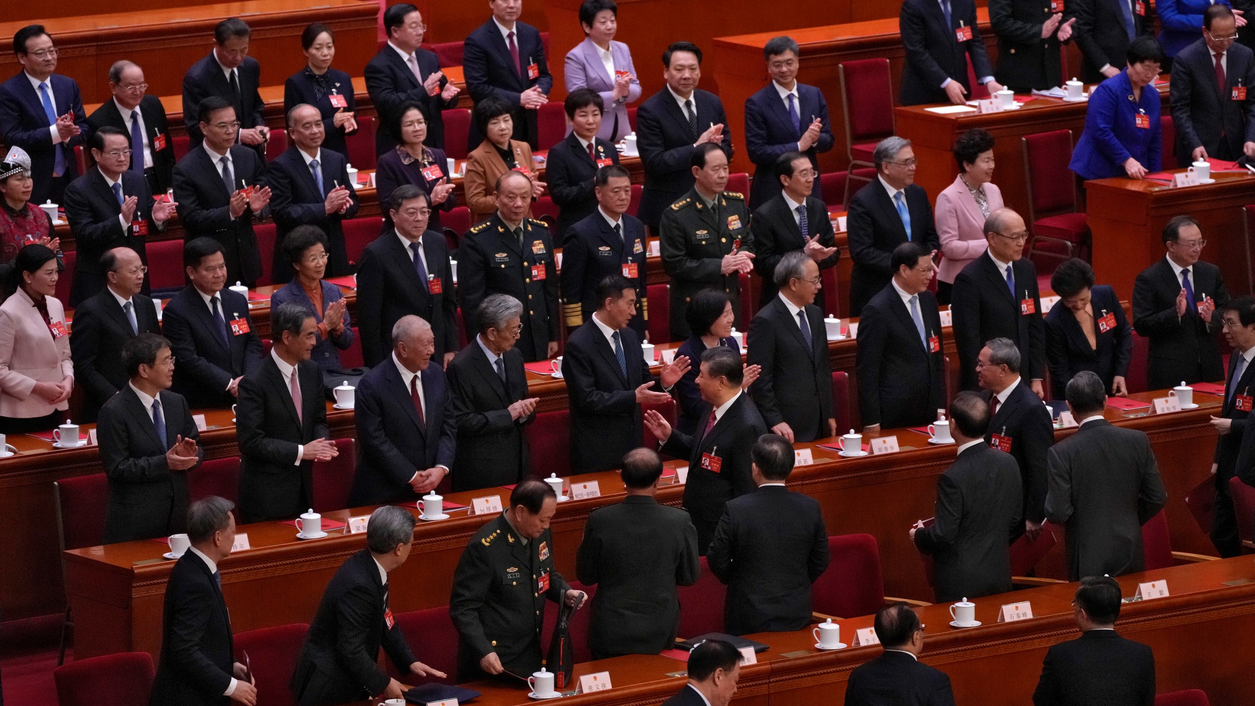 Chinese President Xi Jinping, center, and his Premier Li Qiang, second right in the middle, leave the hall after attending the closing session of the National People's Congress (NPC) at the Great Hall of the People in Beijing, Monday, March 11, 2024. (AP Photo/Andy Wong)