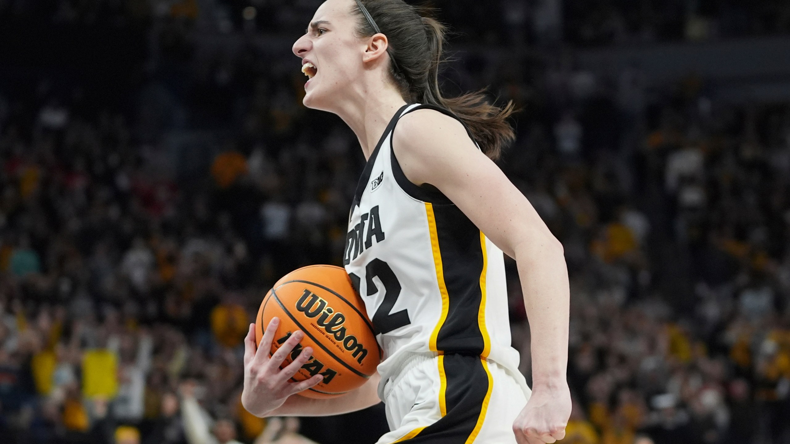 Iowa guard Caitlin Clark celebrates as time expires during the overtime win of an NCAA college basketball game against Nebraska in the final of the Big Ten women's tournament Sunday, March 10, 2024, in Minneapolis. (AP Photo/Abbie Parr)