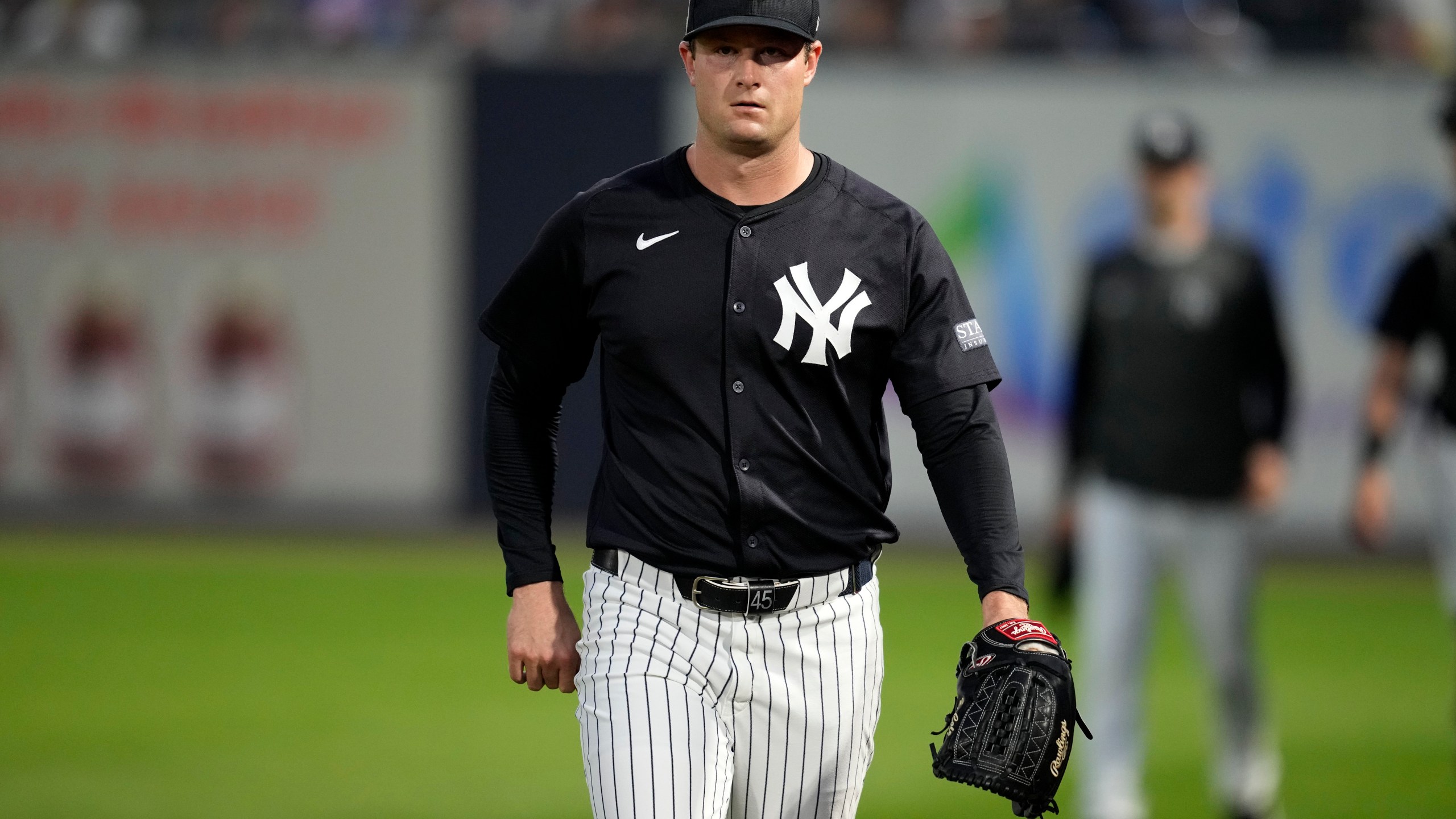 New York Yankees starting pitcher Gerrit Cole walks to the field before a spring training baseball game against the Toronto Blue Jays Friday, March 1, 2024, in Tampa, Fla. (AP Photo/Charlie Neibergall)