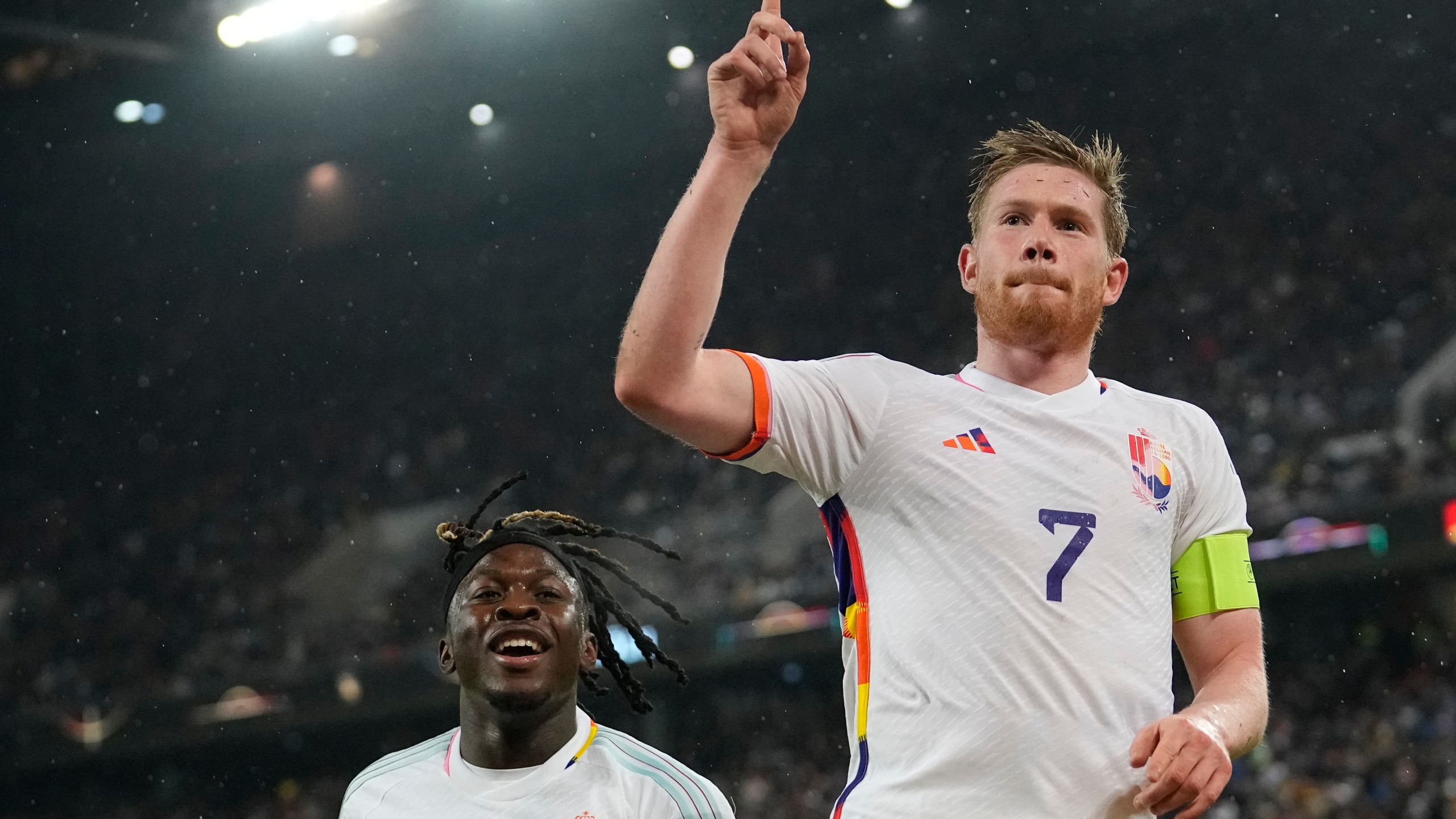 FILE - Belgium's Kevin De Bruyne, right, celebrates after scoring the third goal against Germany during the international friendly soccer match between Germany and Belgium in Cologne, Germany, on March 28, 2023. The Belgium international players taking part in the Euro soccer tournament this summer could well resemble a world-famous reporter. According to leaks on various specialized websites, the Belgium Euro 2024 away kit is a tribute to Tintin. The Belgian federation is set to unveil the new kit on Thursday March 14, 2024 during a press conference at the Hergé Museum. (AP Photo/Martin Meissner, File)