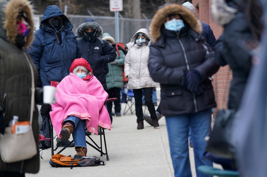 FILE - Judy McKim, center left, waits in line with others for the COVID-19 vaccine in Paterson, N.J., Thursday, Jan. 21, 2021. On March 11, 2024, an independent report examining New Jersey's response to the pandemic said the state and nation were unprepared for it, adding the state is still underprepared for the next crisis. (AP Photo/Seth Wenig, File)