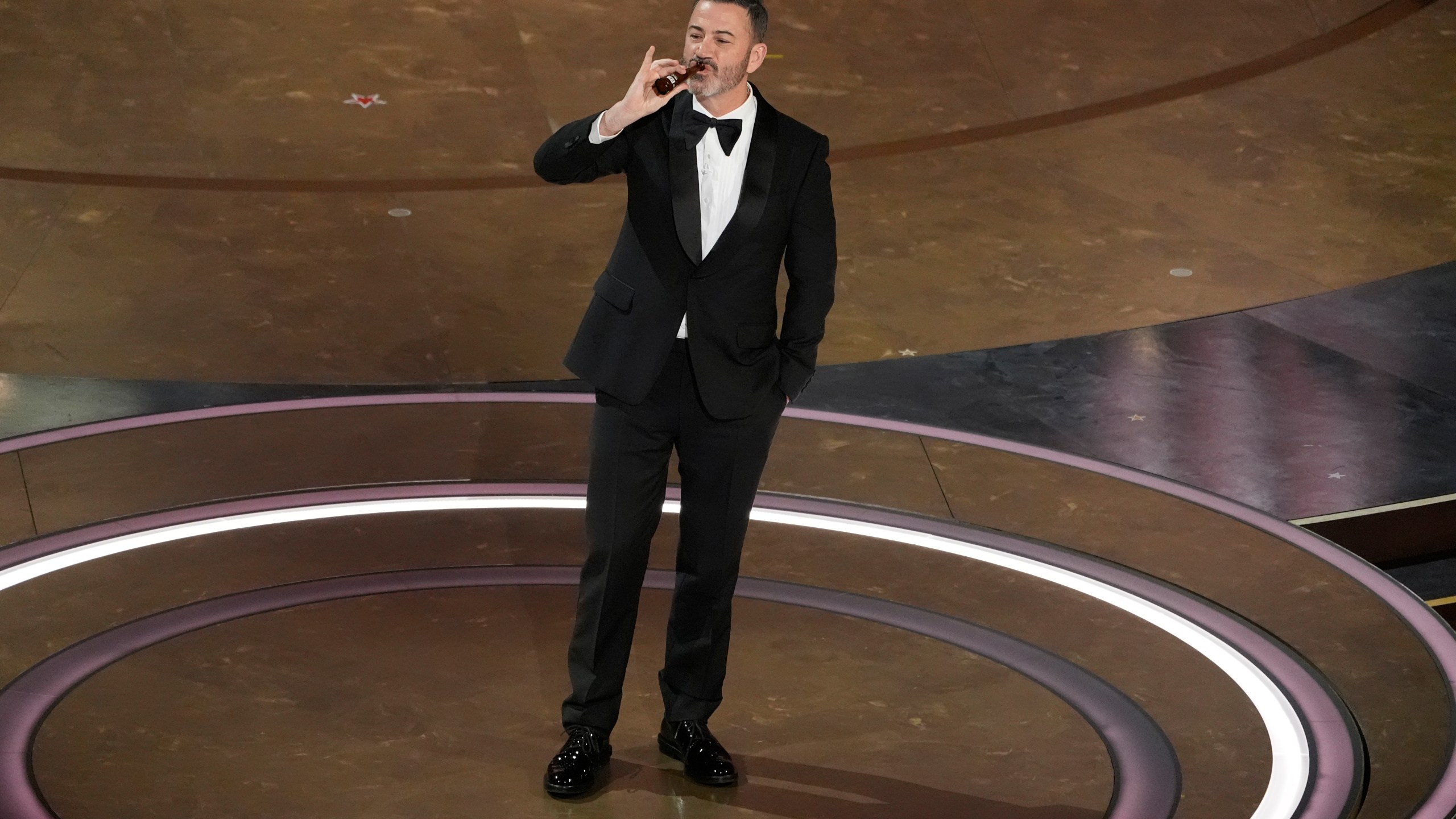 Jimmy Kimmel drinks a shot of tequila during the Oscars on Sunday, March 10, 2024, at the Dolby Theatre in Los Angeles. (AP Photo/Chris Pizzello)