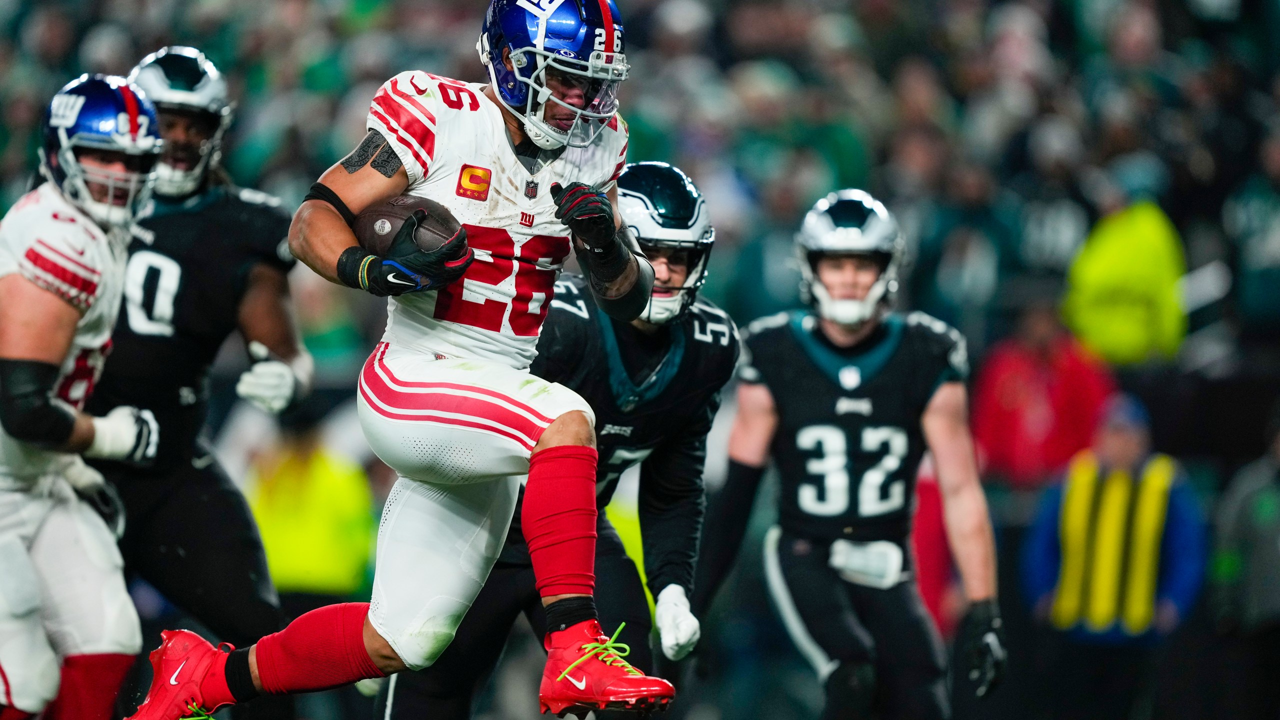 FILE - New York Giants running back Saquon Barkley runs for a touchdown against the Philadelphia Eagles during the second half of an NFL football game Monday, Dec. 25, 2023, in Philadelphia. The Philadelphia Eagles have agreed to contracts with former New York Giants running back Saquon Barkley and former New York Jets defensive end Bryce Huff, two people familiar with the deals told The Associated Press on Monday, March 11, 2024. (AP Photo/Matt Rourke, File)
