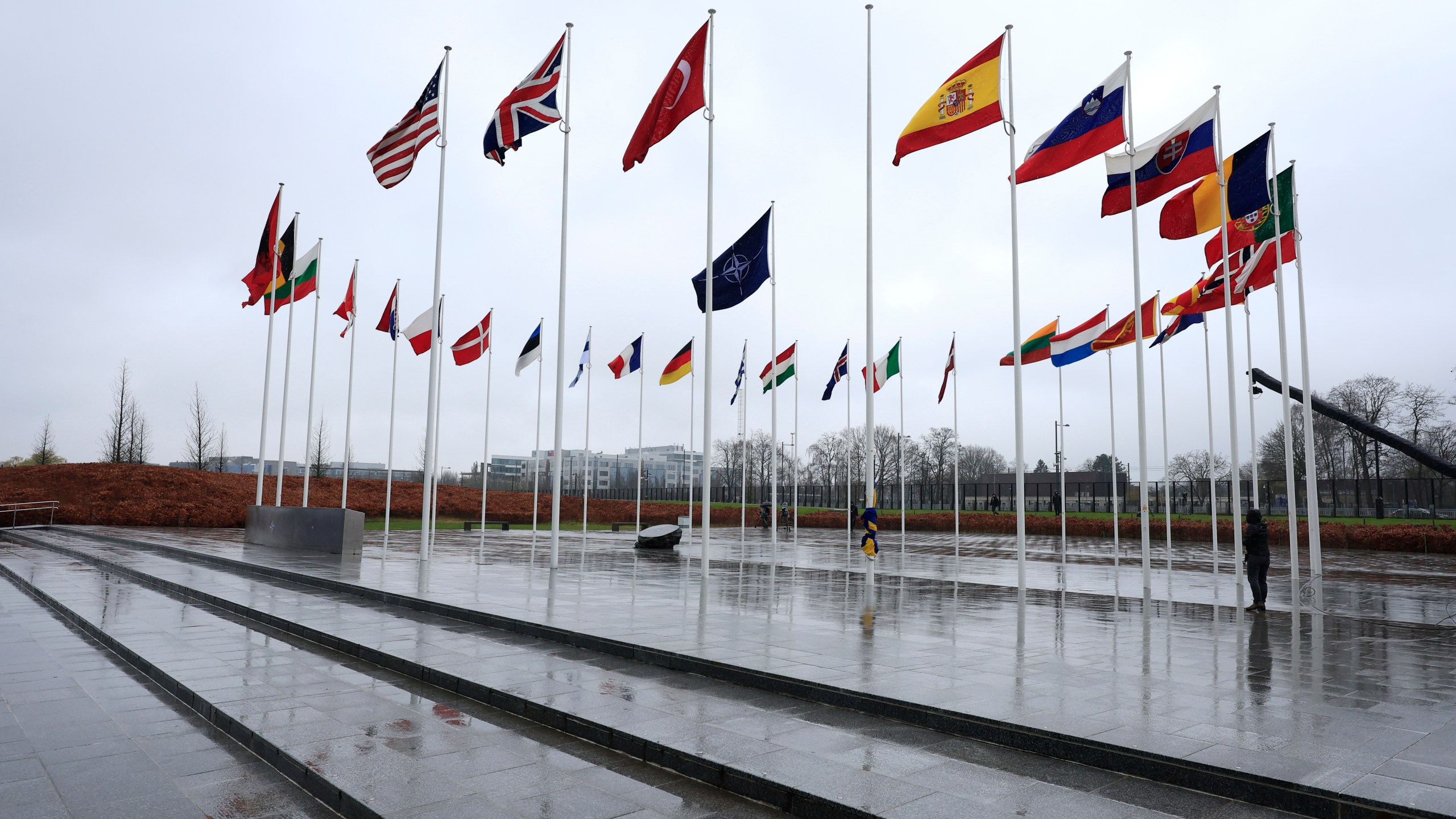 Flags of NATO nations flap in the wind along with an empty flagpole as protocol prepare for a flag raising ceremony to mark the accession of Sweden at NATO headquarters in Brussels, Monday, March 11, 2024. Sweden has formally joined NATO as the 32nd member of the transatlantic military alliance, ending decades of post-World War II neutrality and centuries of broader non-alignment with major powers as security concerns in Europe have spiked following Russia's 2022 invasion of Ukraine. (AP Photo/Geert Vanden Wijngaert)