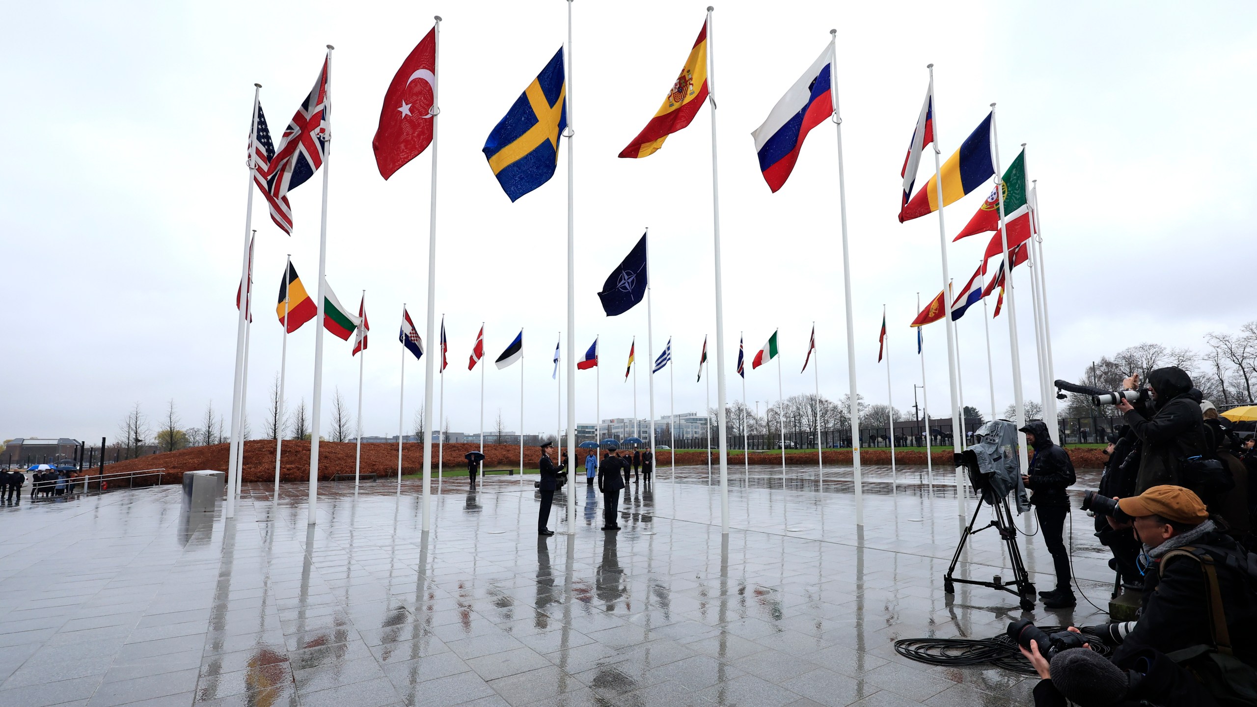 Members of the military raise the flag of Sweden on its newly installed pole during a ceremony to mark the accession of Sweden to NATO at NATO headquarters in Brussels, Monday, March 11, 2024. (AP Photo/Geert Vanden Wijngaert)