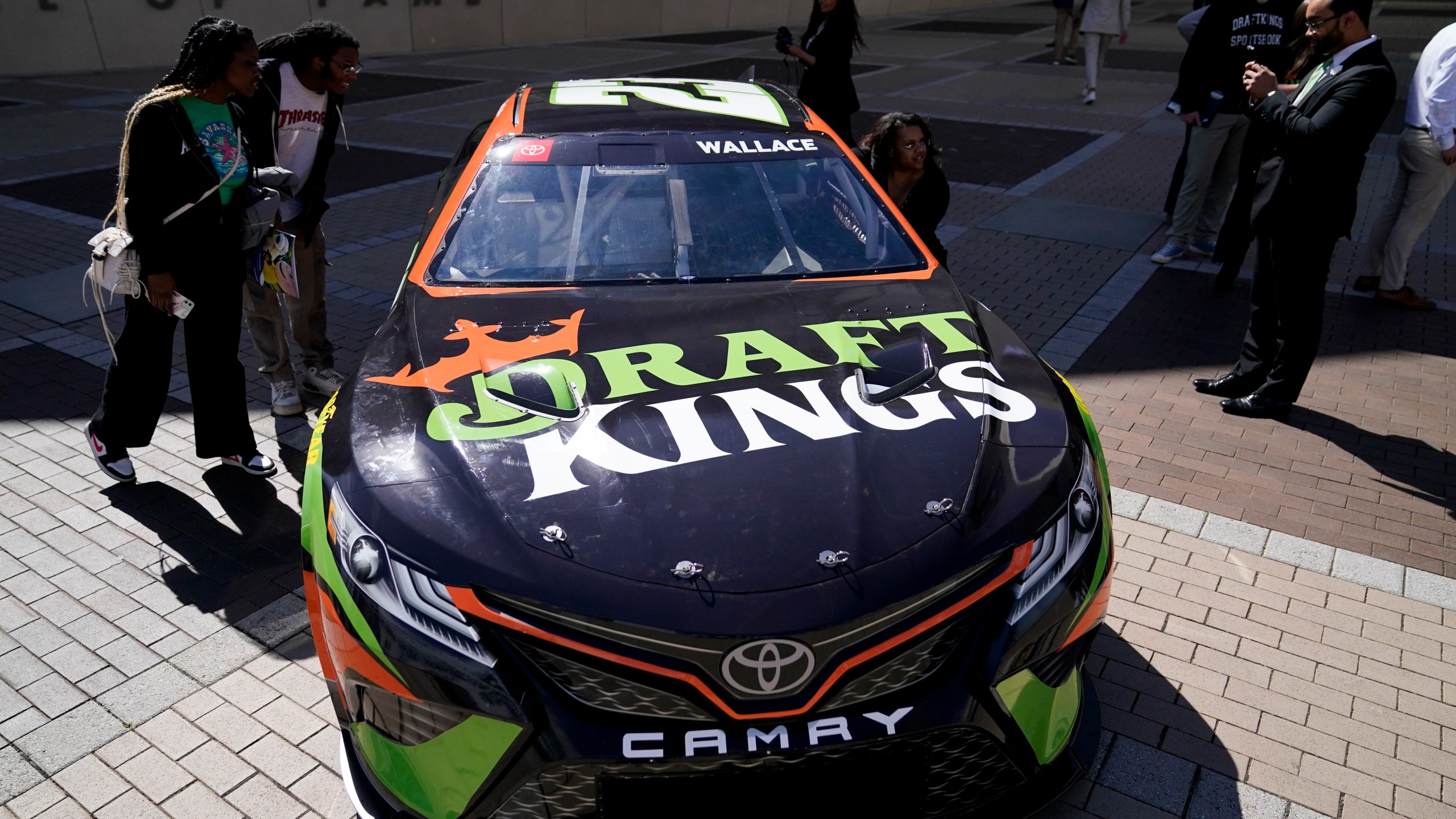The DraftKings's Bubba Wallace NASCAR car is displayed outside the NASCAR Hall of Fame during an event celebrating the launch of mobile and online sports wagering across North Carolina, Monday, March 11, 2024, in Charlotte, N.C. (AP Photo/Erik Verduzco)