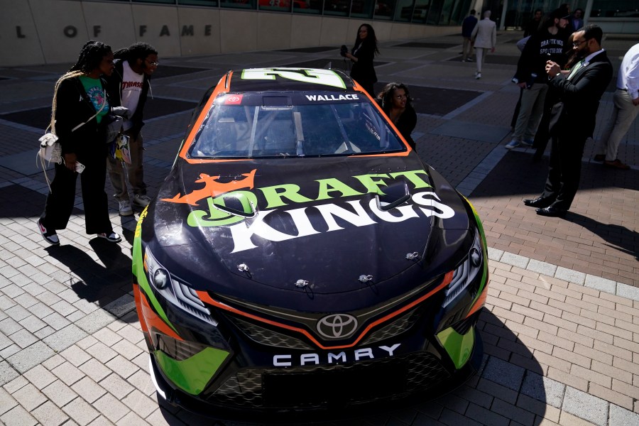 The DraftKings's Bubba Wallace NASCAR car is displayed outside the NASCAR Hall of Fame during an event celebrating the launch of mobile and online sports wagering across North Carolina, Monday, March 11, 2024, in Charlotte, N.C. (AP Photo/Erik Verduzco)