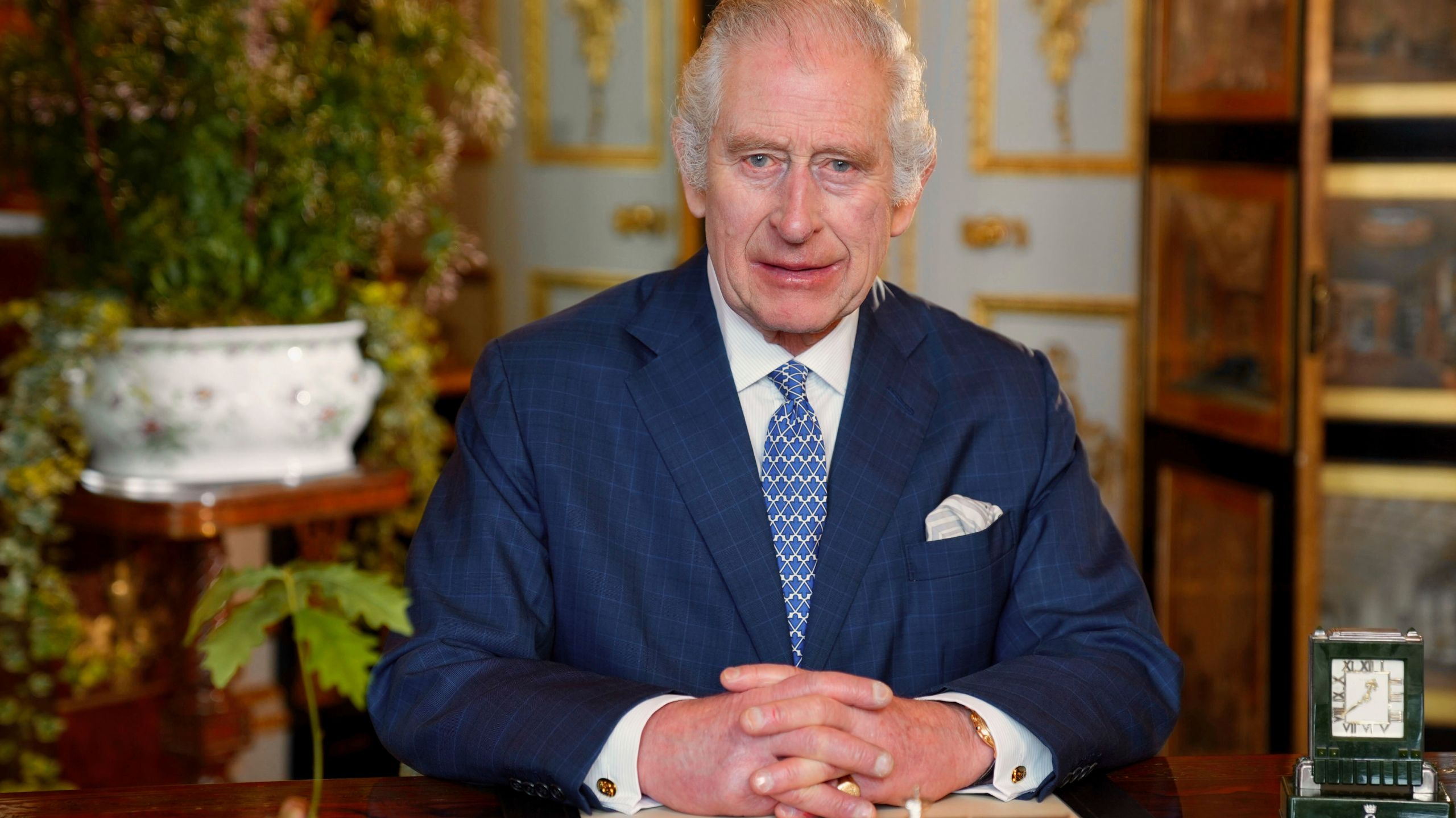 In this photo issued by the Royal Household on Monday March 11, 2024, Britain's King Charles III records the King's Commonwealth message, which was filmed in the White Drawing Room at Windsor Castle, Windsor, England in Feb. 2024. The King has pledged to continue to serve the Commonwealth "to the best of my ability", in his annual address to the family of nations. (Royal Household via AP)