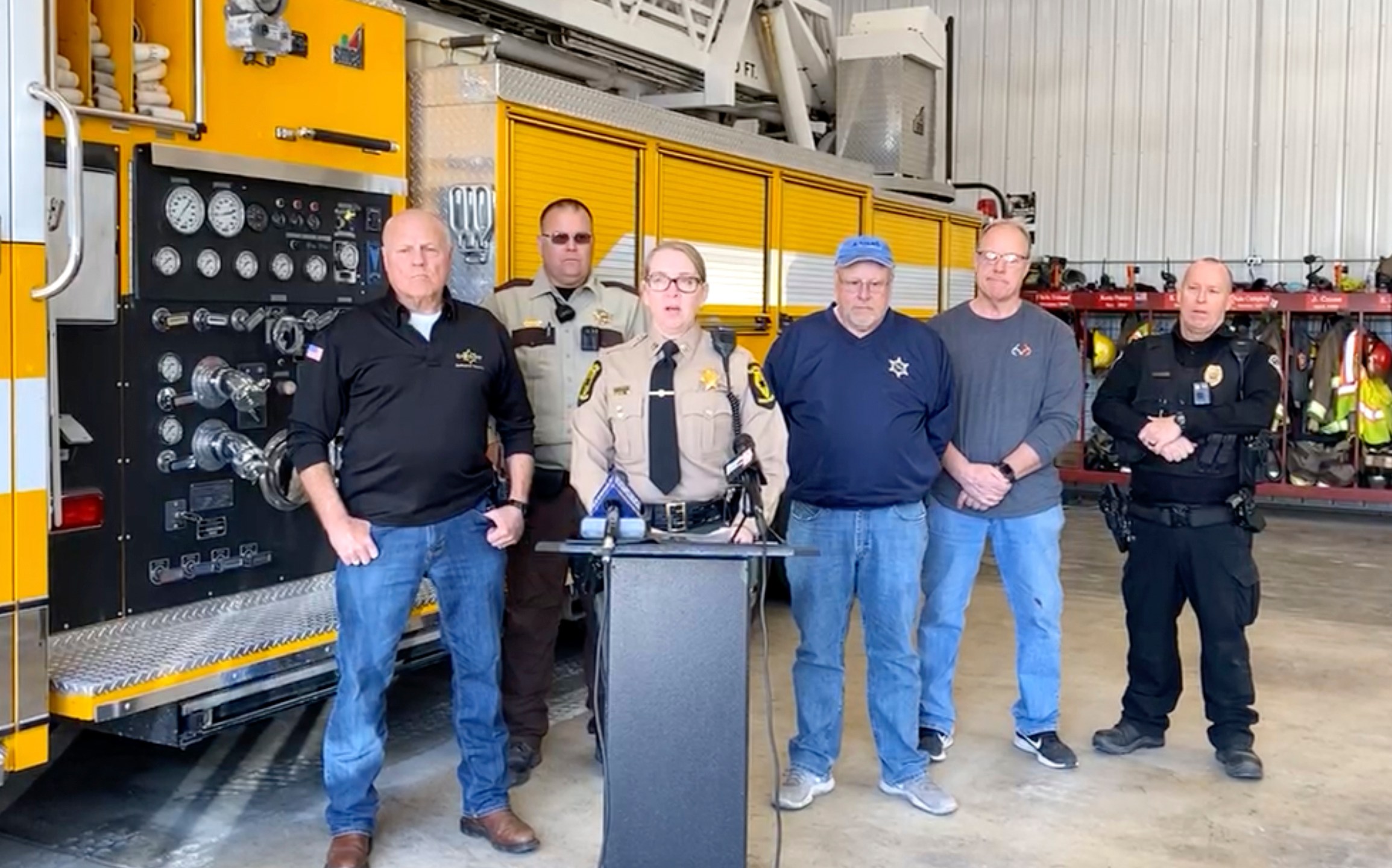 In this image made from video provided by Illinois State Police Troop 6, Illinois State Police Capt. Jody Huffman, at podium, speaks during a news conference about the five people, including three children, who were killed Monday, March 11, 2024, after a school bus and semitruck collided on a highway in western Illinois. (Illinois State Police Troop 6 via AP)