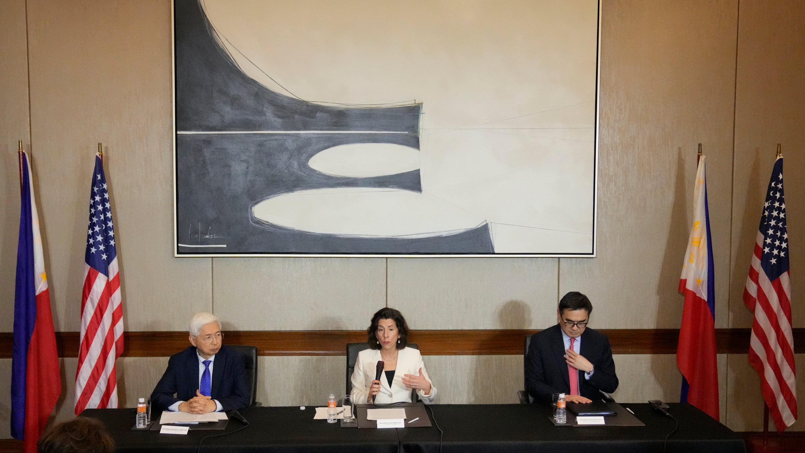 U.S. Commerce Secretary Gina Raimondo, centrt, gestures beside Philippine Trade and Industry Secretary Alfredo Pascual, left, and Special Assistant to the President for Investment and Economic Affairs Frederick Go, during a press conference at Paranaque city, Philippines on Monday, March 11, 2024. Raimondo led a U.S. Presidential Trade and Investment Mission which aims to boost US contributions to the Philippines and to further strengthen bilateral economic ties. (AP Photo/Aaron Favila)