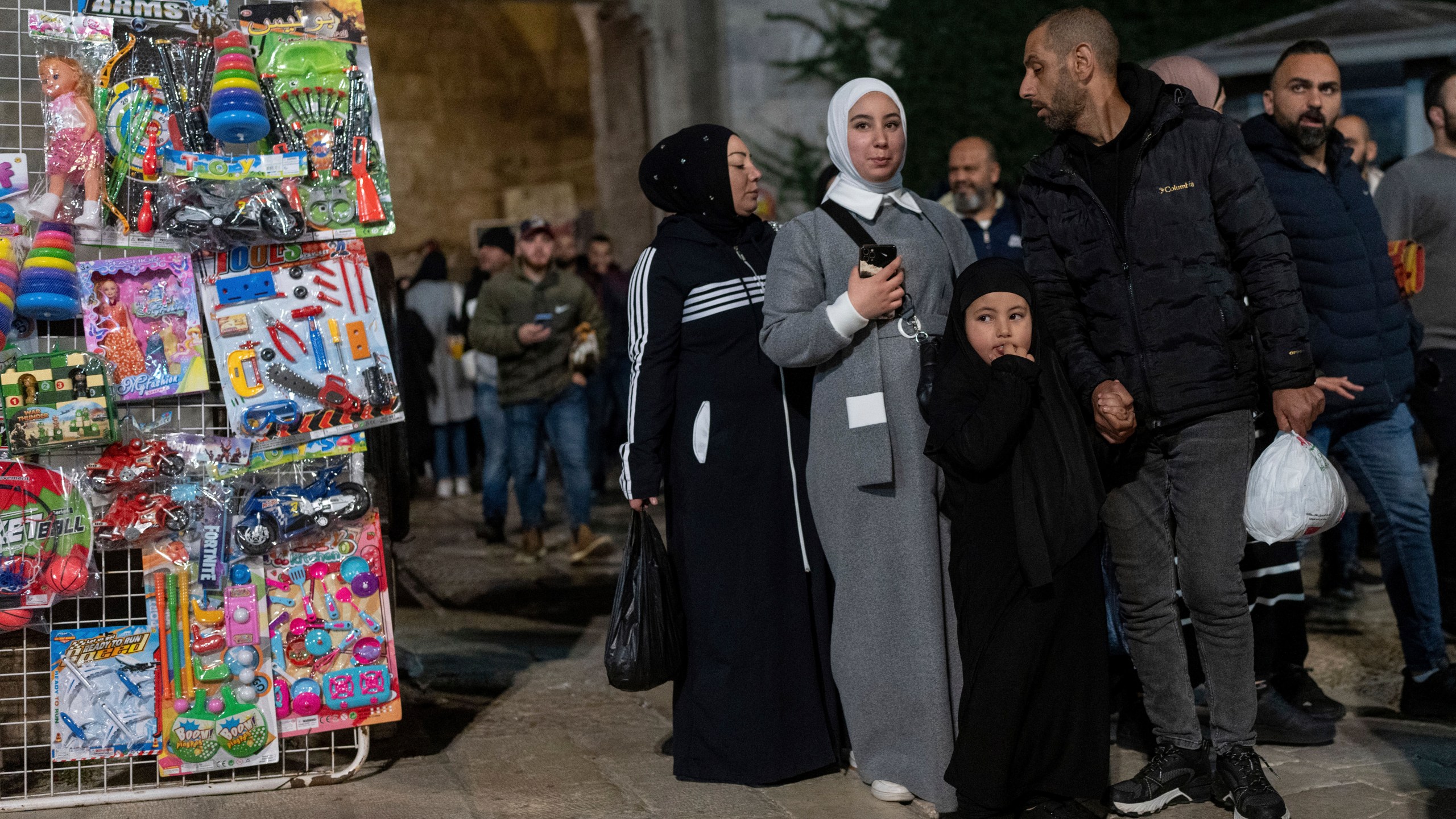 People walk in front of the Damascus gate in the Old City of Jerusalem, on the first day of Ramadan, Monday, March 11, 2024. (AP Photo/Ohad Zwigenberg)