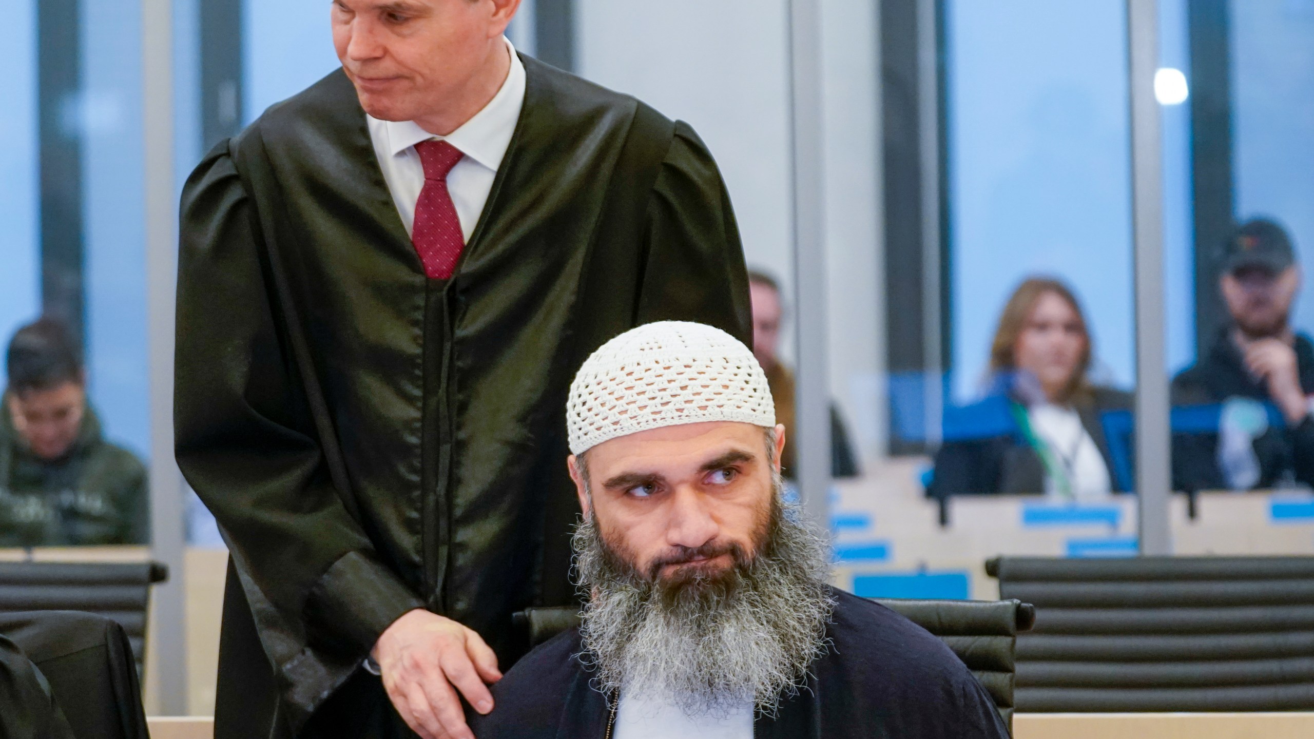 Zaniar Matapour with defense attorney Marius Dietrichson in Oslo courthouse Tuesday, March 12, 2024. The trial has begun in Norway for a man accused of aggravated terrorism for the deadly shooting at an LGBTQ+ festival in Oslo’s nightlife district. Two people were killed and nine seriously wounded in the shooting in June 2022. The prosecutor says the Norwegian citizen originally from Iran had sworn allegiance to the Islamic State group. (Lise Åserud/NTB Scanpix via AP)