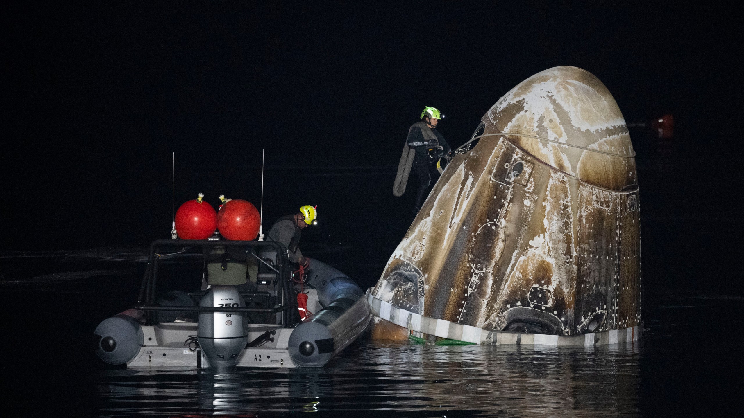 Support teams work around the SpaceX Dragon Endurance spacecraft shortly after it landed with NASA astronaut Jasmin Moghbeli, European Space Agency astronaut Andreas Mogensen, Japan Aerospace Exploration Agency astronaut Satoshi Furukawa, and Russia cosmonaut Konstantin Borisov aboard in the Gulf of Mexico off the coast of Pensacola, Fla., Tuesday, March 12, 2024. (Joel Kowsky/NASA via AP)